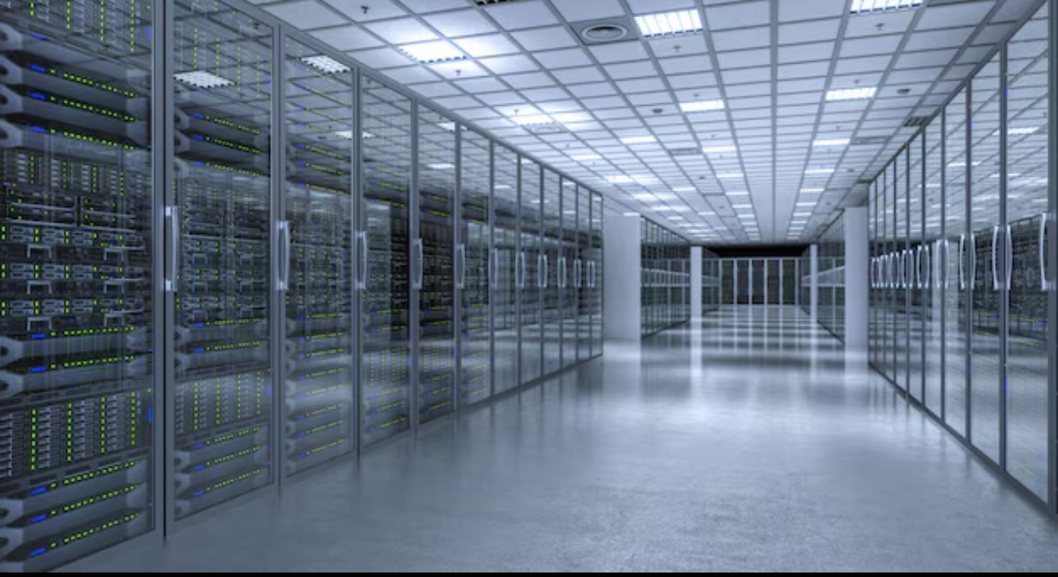 A large, modern server room with rows of server racks enclosed in glass doors, bright lighting, and a clean, polished floor.