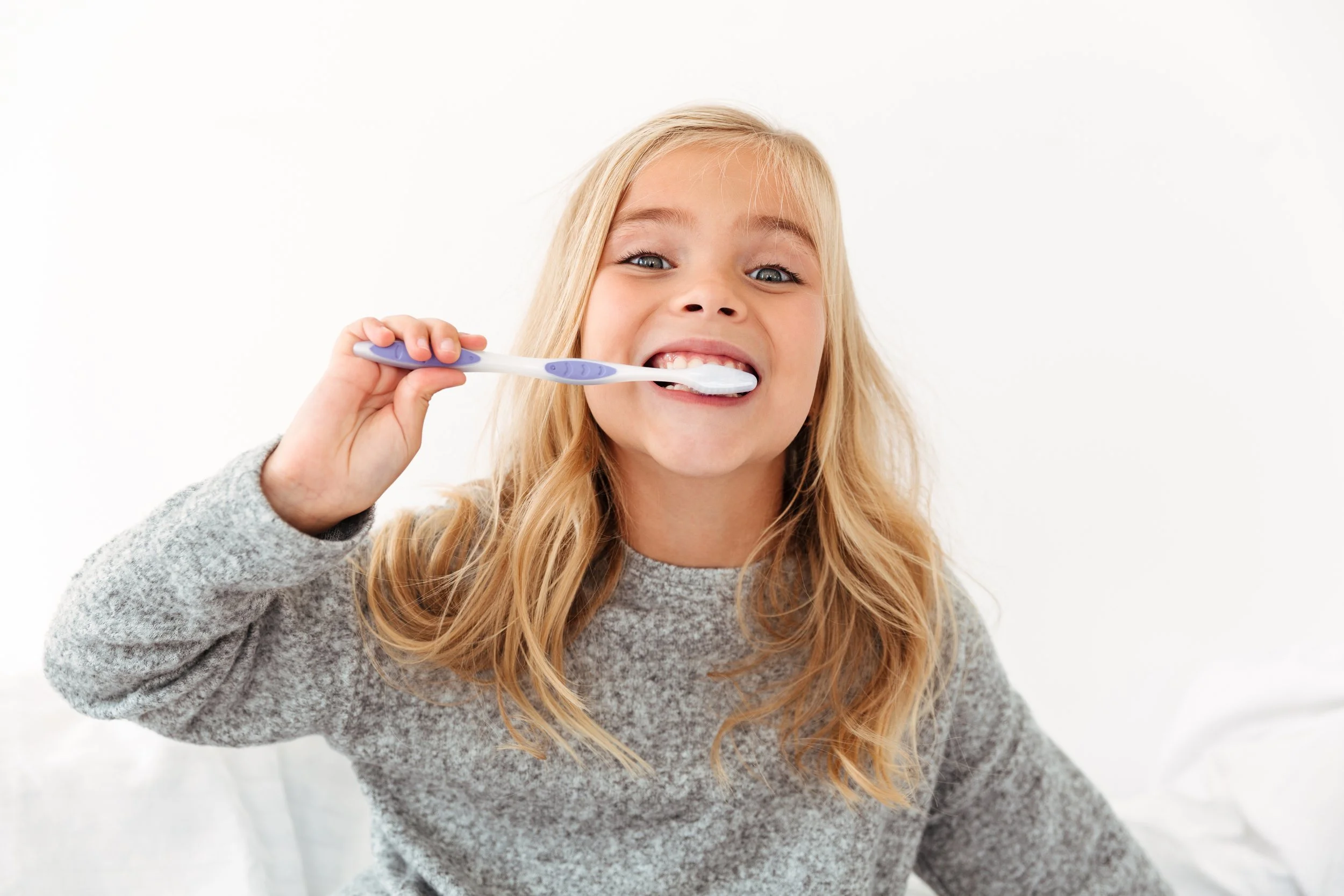 A girl brushing her teeth