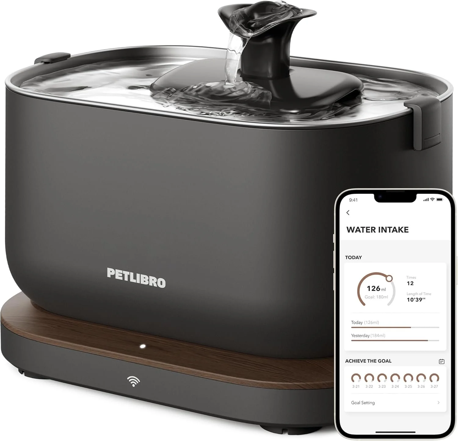 A Petlibro water fountain with a dark gray body and a wooden base, with water flowing from a spout. A smartphone showing a water intake tracking app is placed in front of the fountain.