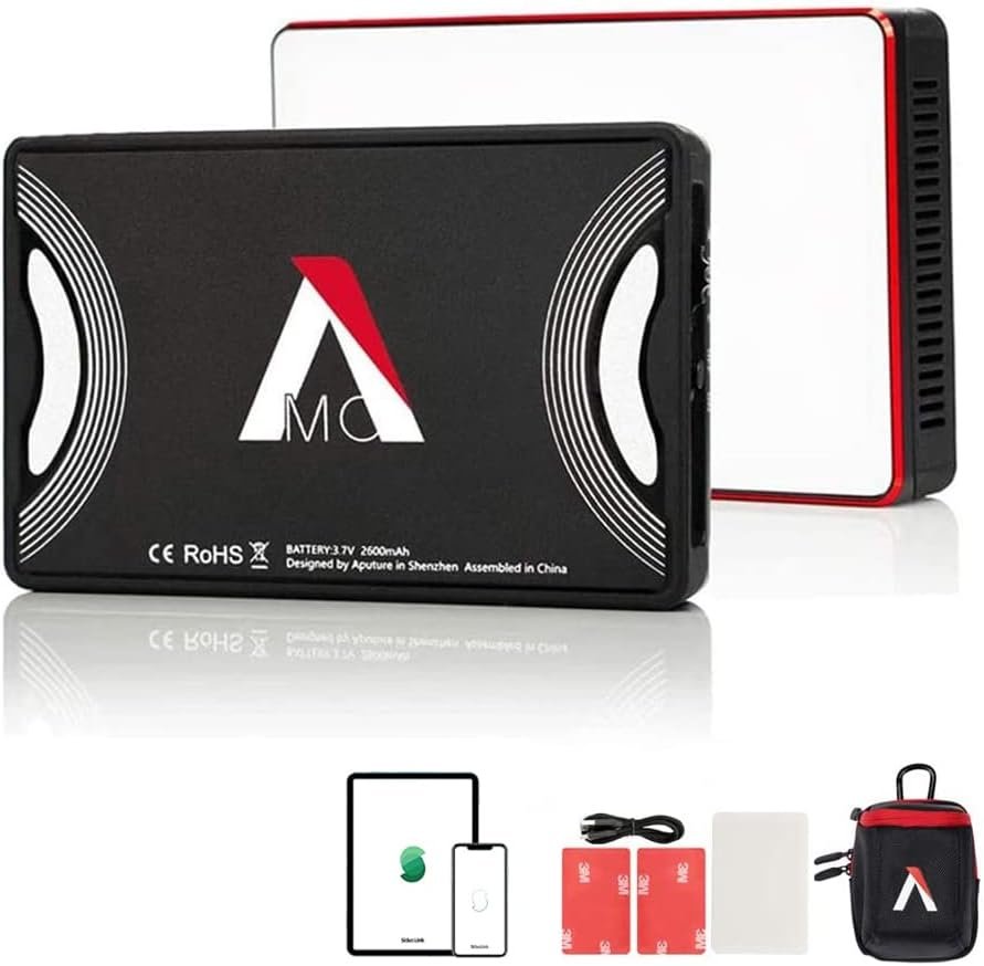 Portable audio recorder with a black body, white and red accents, and a logo, accompanied by accessories including a larger primary device, a protective carrying case, adhesive hooks, a USB cable, a battery, and a carrying pouch.