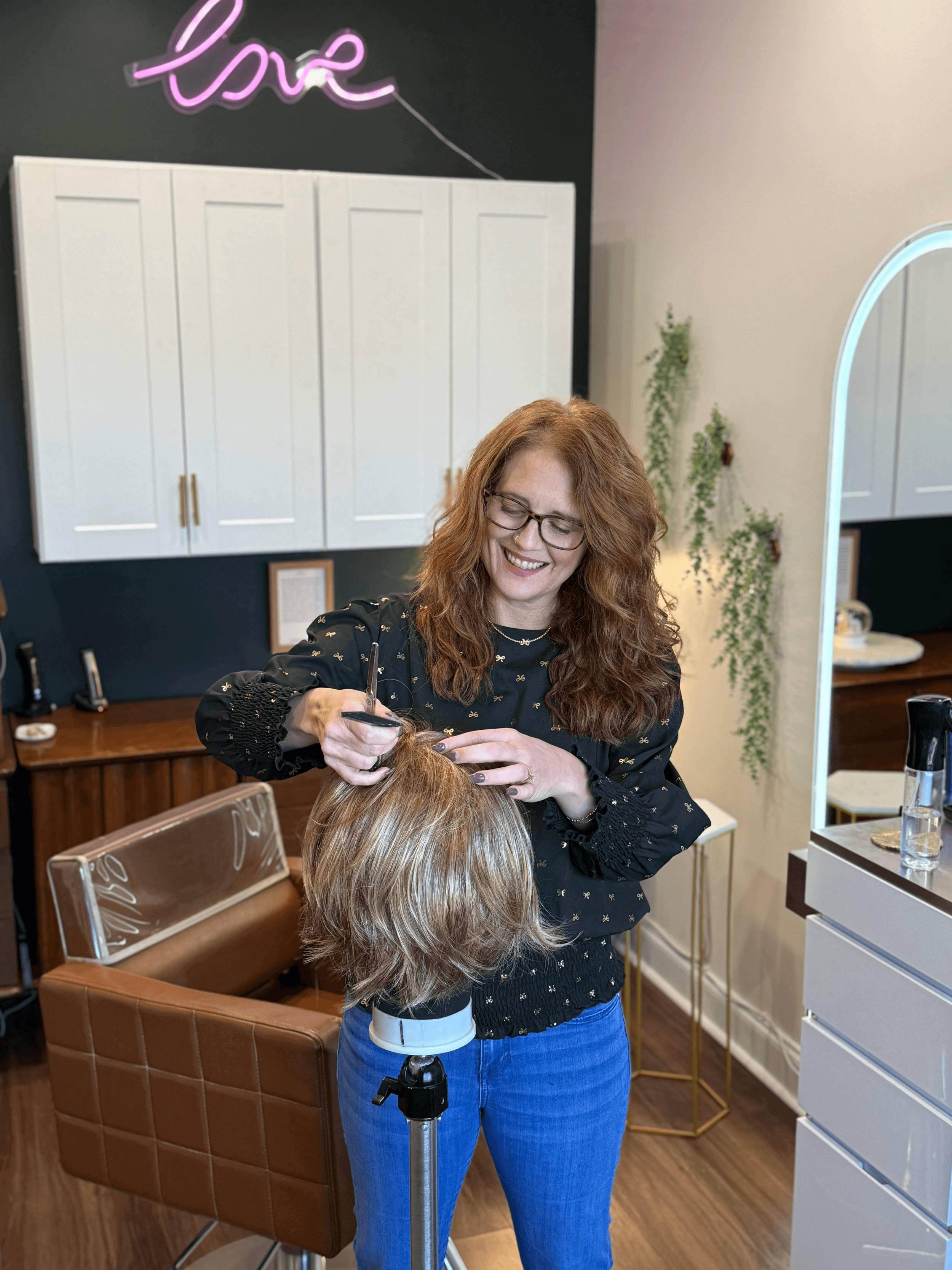 Suzi Watkins board certified trichologist and certified Alternative Hair Specialist customizing an alternative hair wig during a personalized consultation at Root Revival Hair Restoration in Cumming Georgia serving Forsyth County