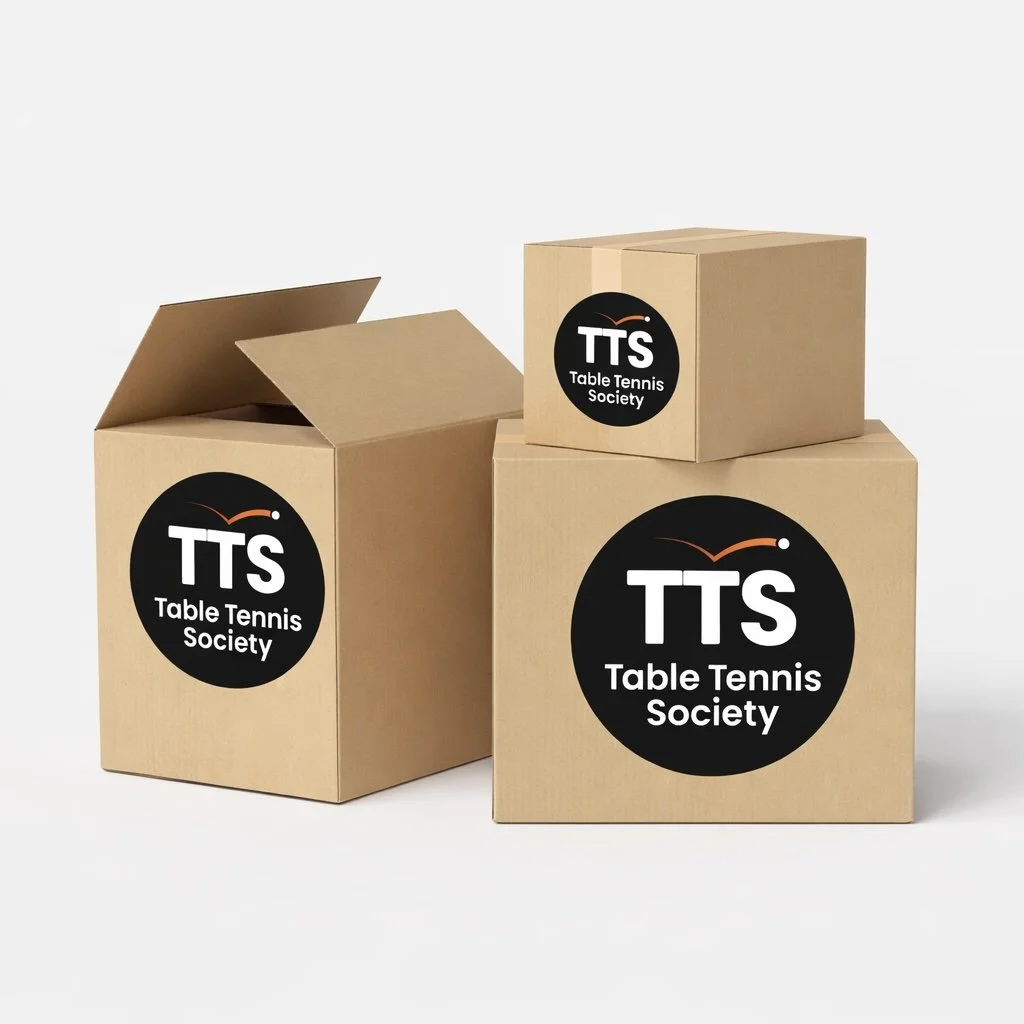 Three brown cardboard boxes with Table Tennis Society logo printed on it. One box is half open.