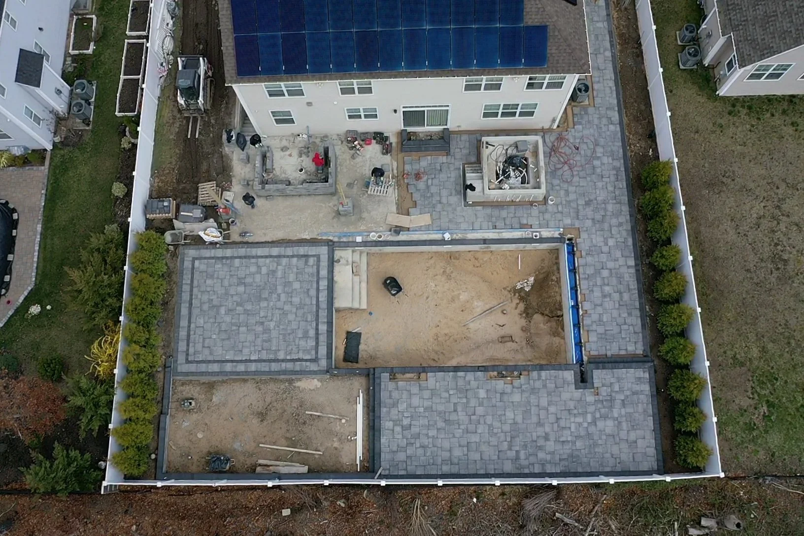 During inground pool and paver patio construction with excavation and hardscape work in Ridge, NY