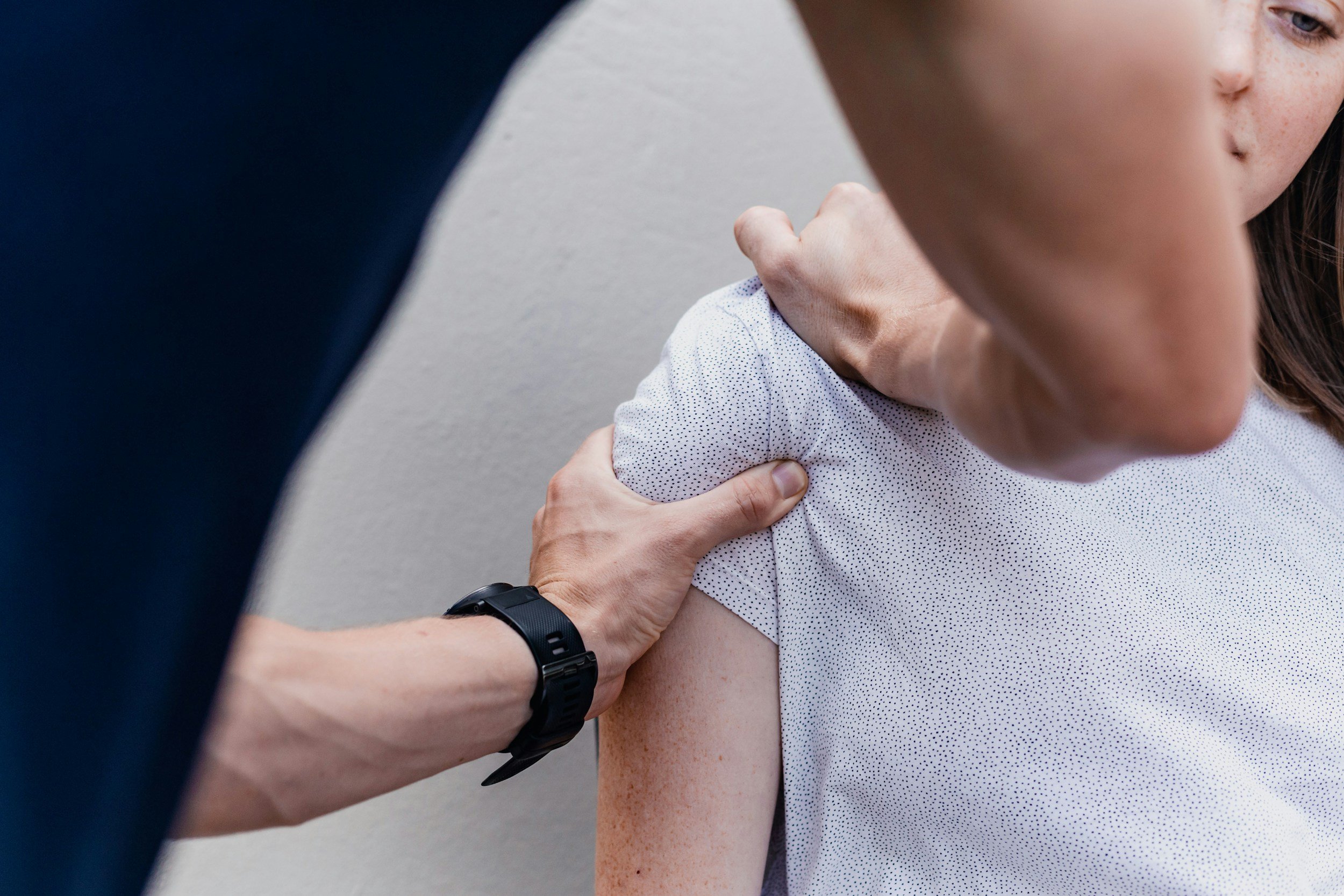 A person receiving a vaccination or injection in their upper arm from a healthcare worker.