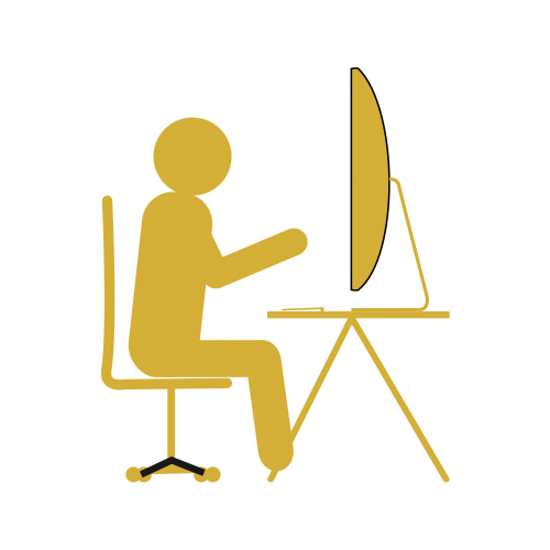 Silhouette of a person sitting at a desk with a computer monitor in front of them.