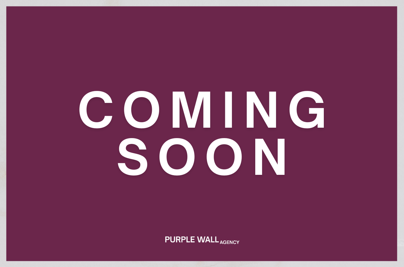 A purple background with white text reading 'COMING SOON' and smaller text at the bottom that says 'PURPLE WALL AGENCY'.