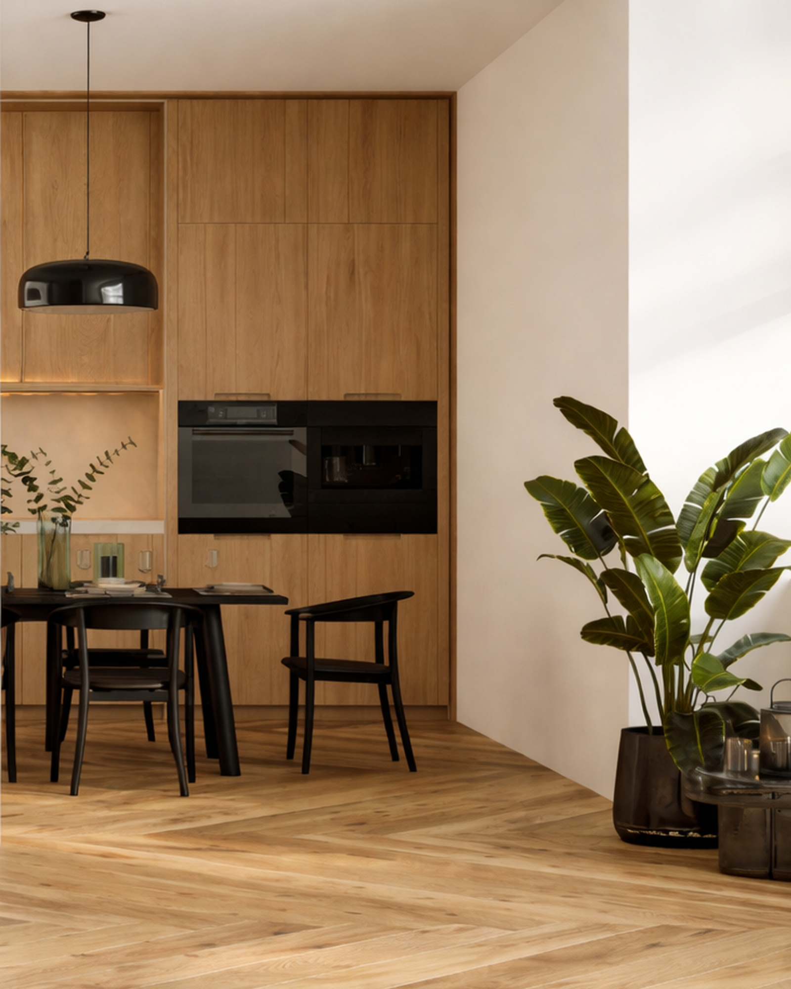Modern dining area with black dining table and chairs, built-in wooden cabinets, and a large potted plant in a black planter.