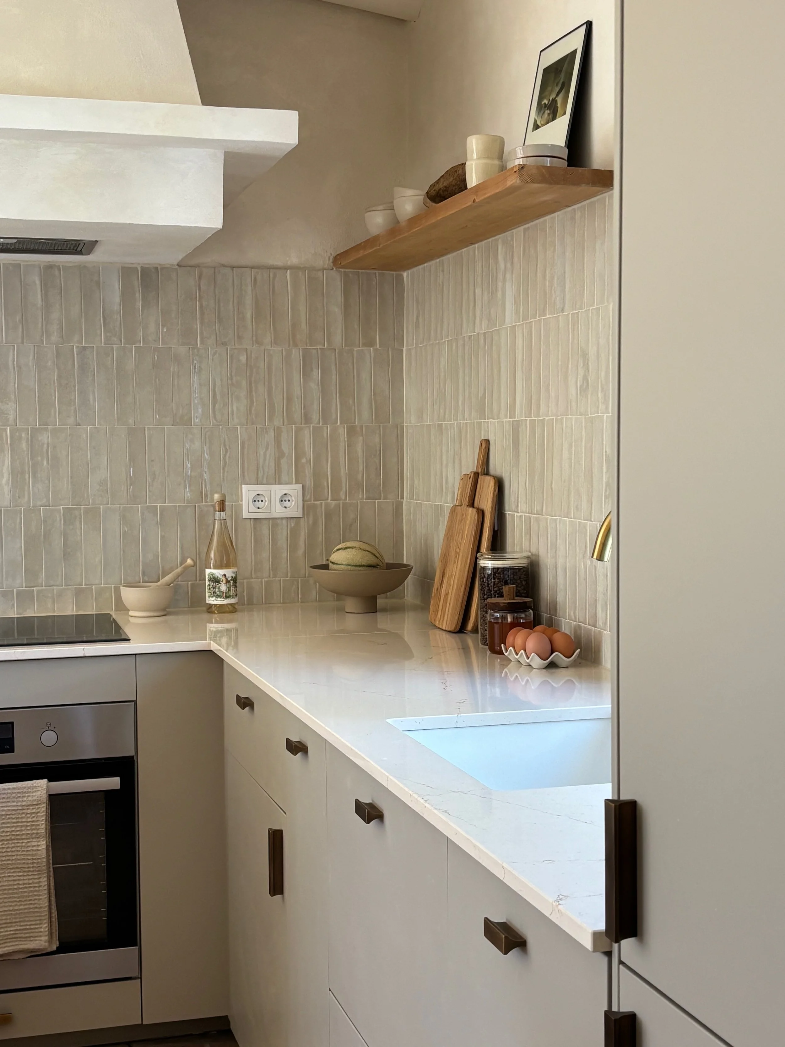 Kitchen counter with cutting boards, eggs, jars, and a decorative bowl