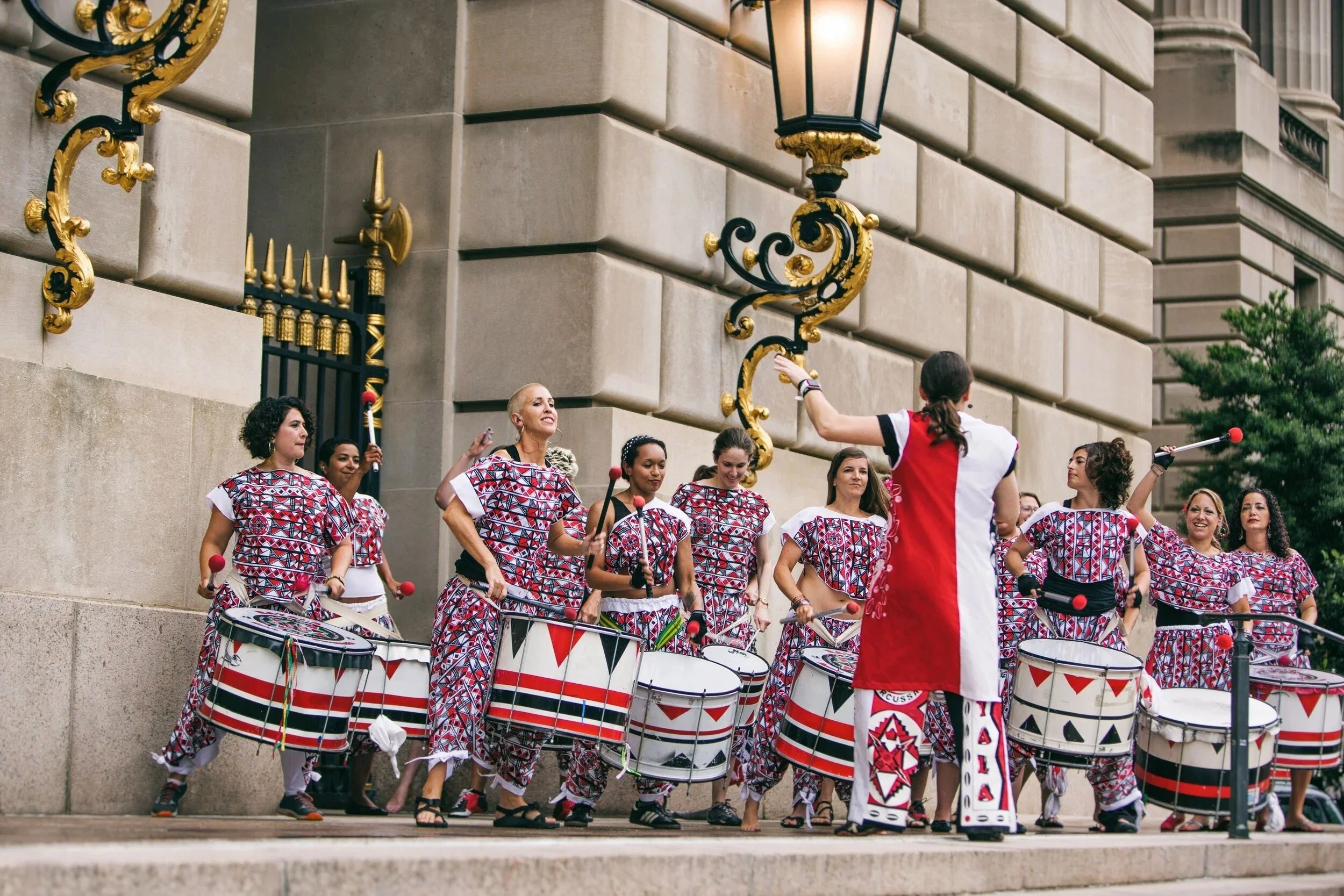 people on the street playing drums
