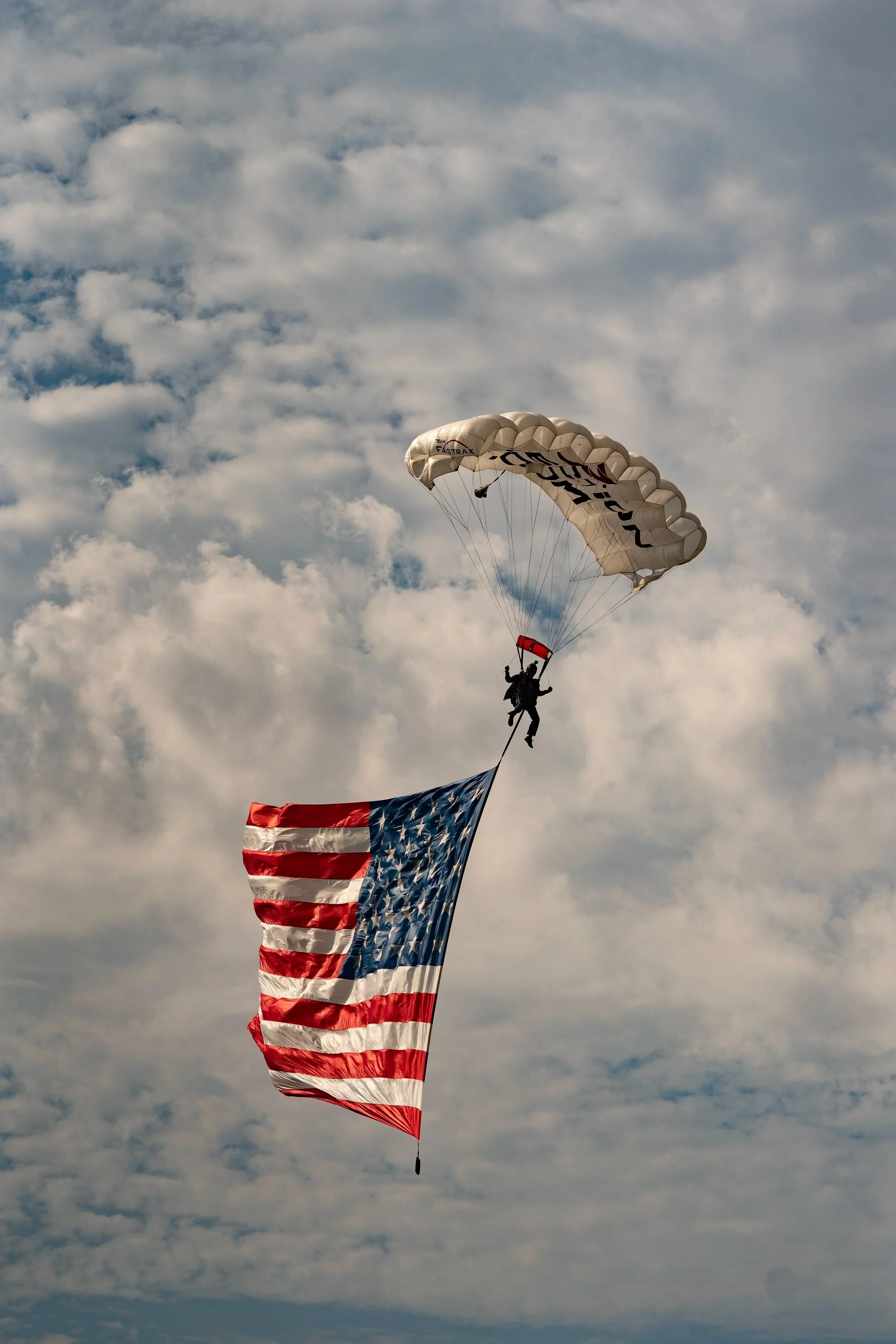 a guy flying holding USA flag