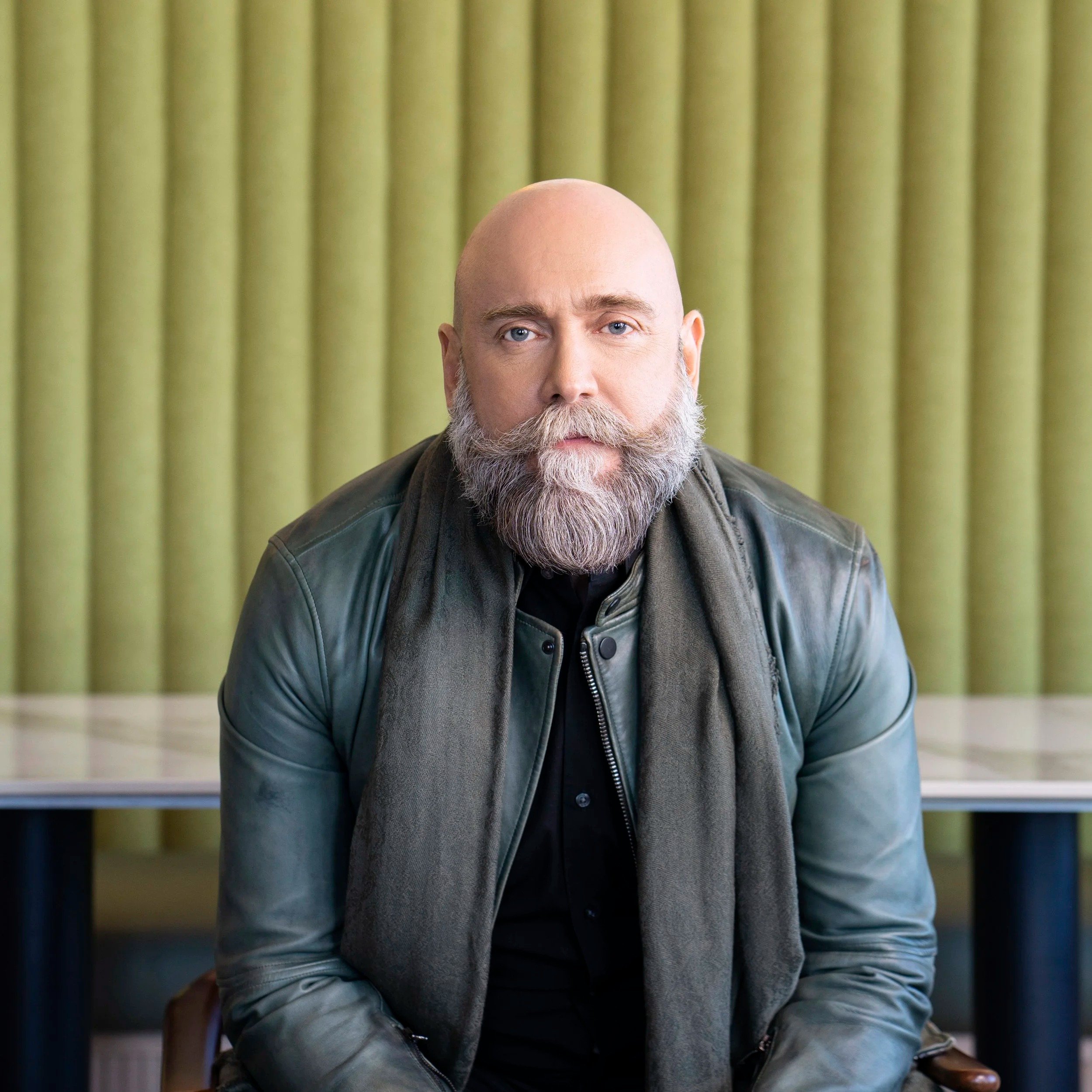 bald man with big mustach having a photoshoot