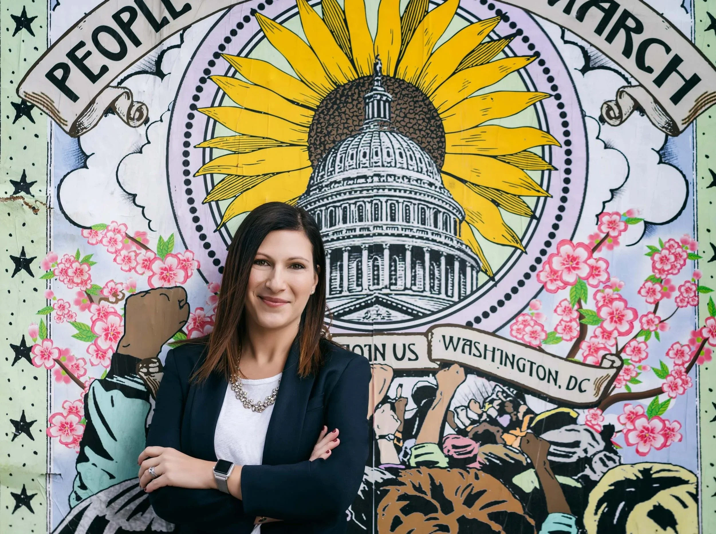 woman standing behind a graffity