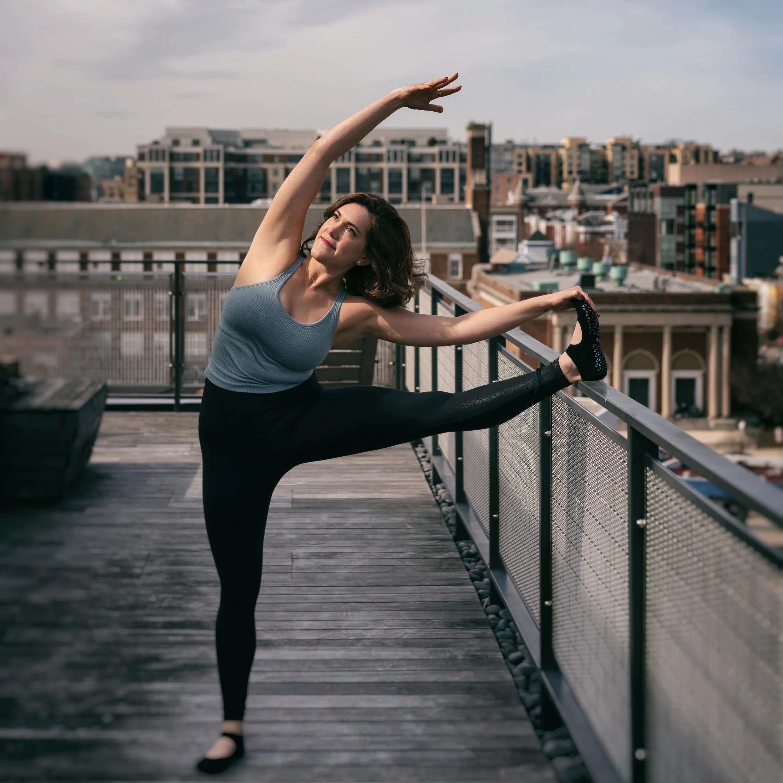 woman doing a yoga pose by streching her legs