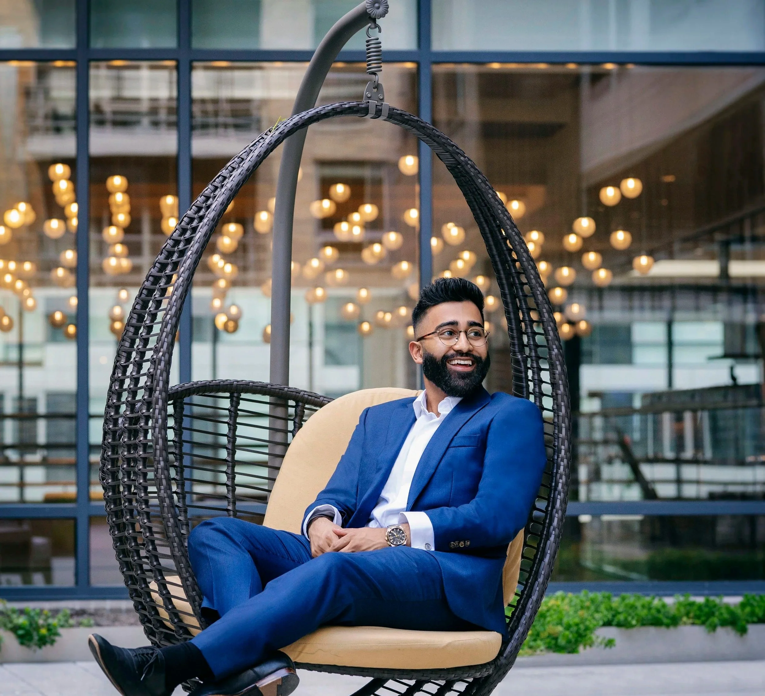 man wearing a blue suit laughing for photoshoot