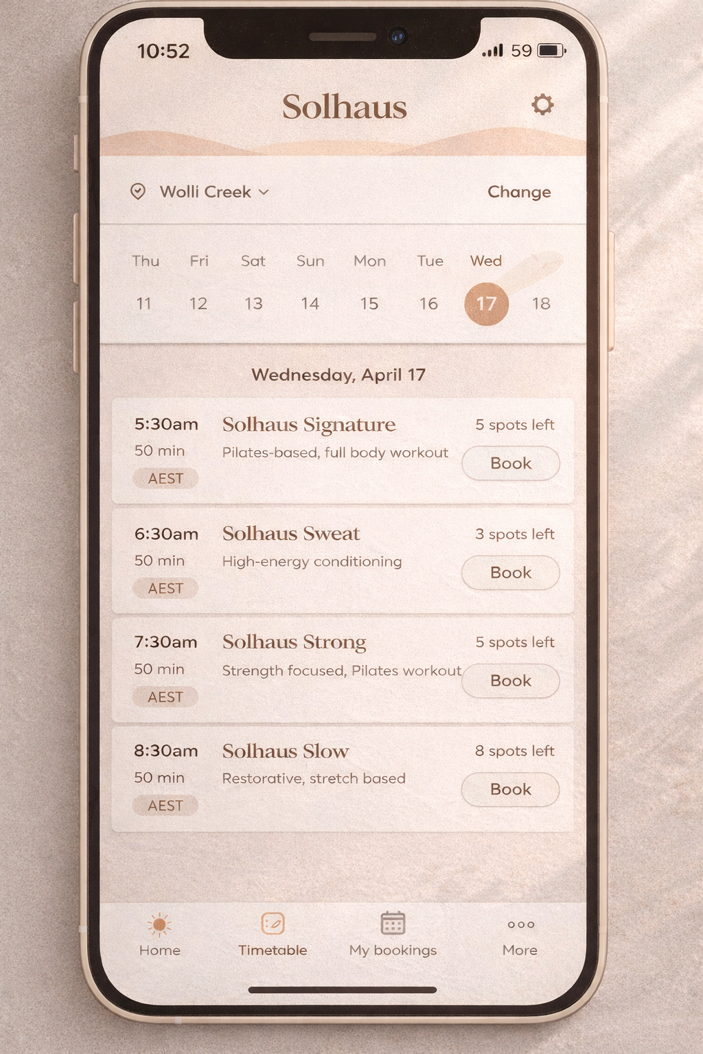 Smartphone screen displaying the Solhaus app with various Pilates classes scheduled for Wednesday, April 17, including times, class types, and booking options.