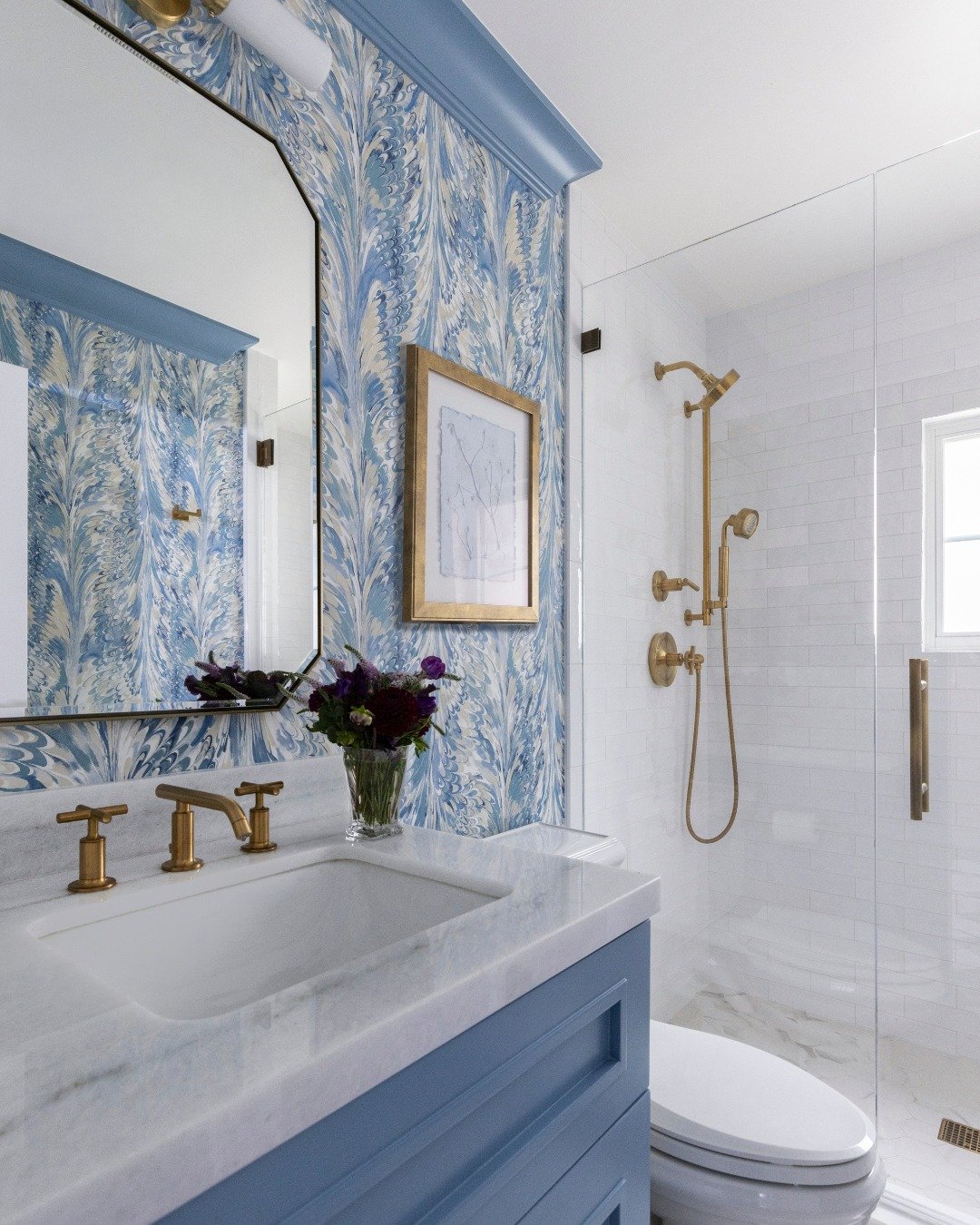 Soft blues, warm brass, and layers that make the whole space feel calm the moment you walk in.

We wanted this bathroom to feel polished and timeless while still having a little personality. The movement in the wallpaper adds such a beautiful softnes