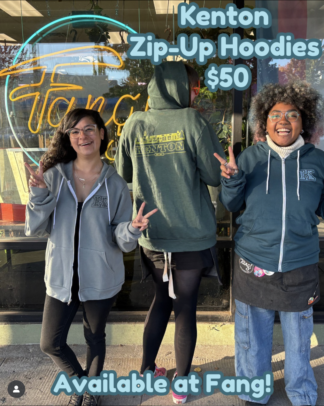 Three people modeling Kenton zip-up hoodies while standing in front of Fang! storefront.