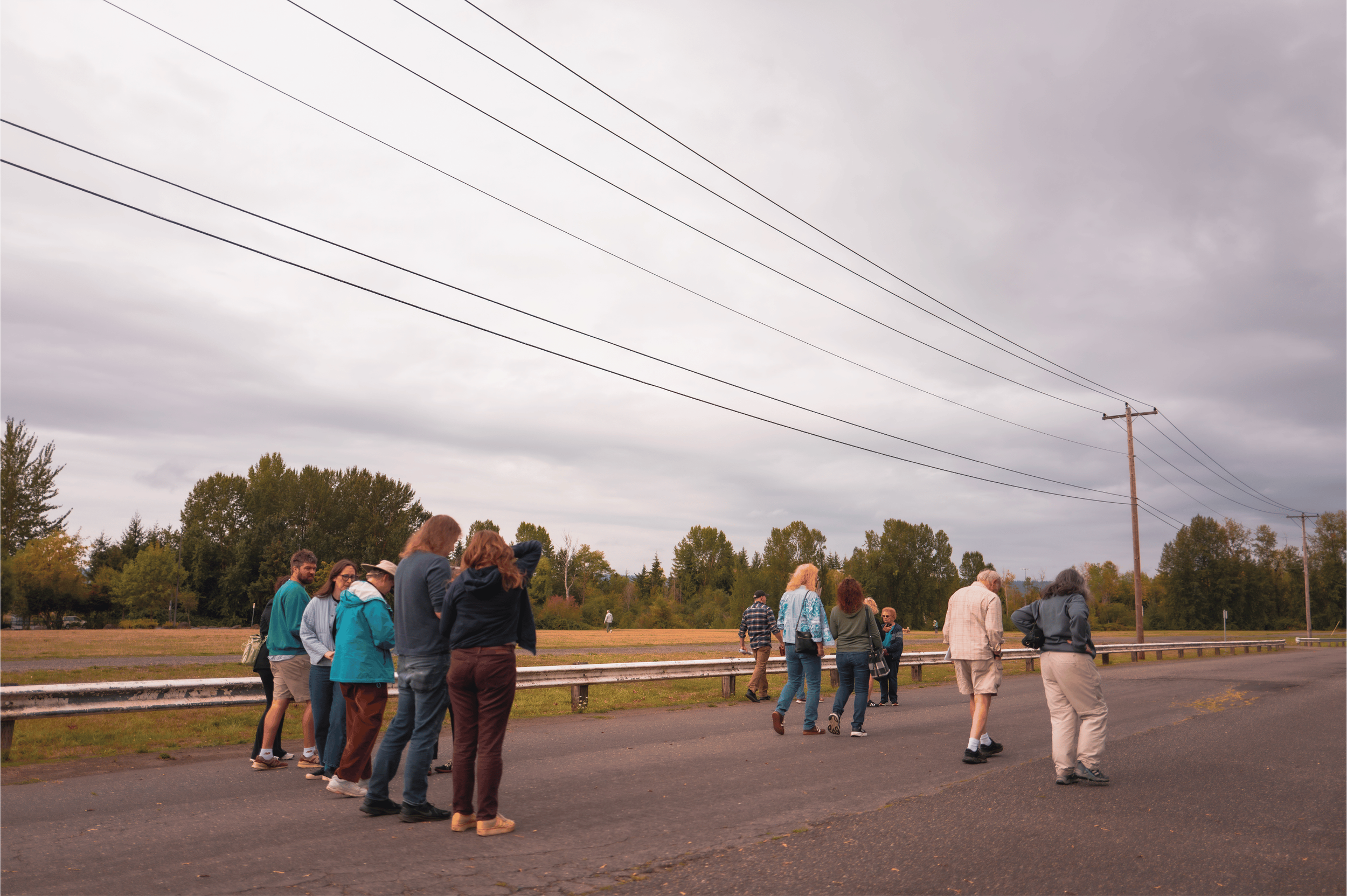  Bus tour participants walking through Delta Park, the former site of historic Vanport, during a guided neighborhood tour stop for Kenton Roots on September 12, 2026.  Photo: Troy Winslow / Vanport Mosaic.  