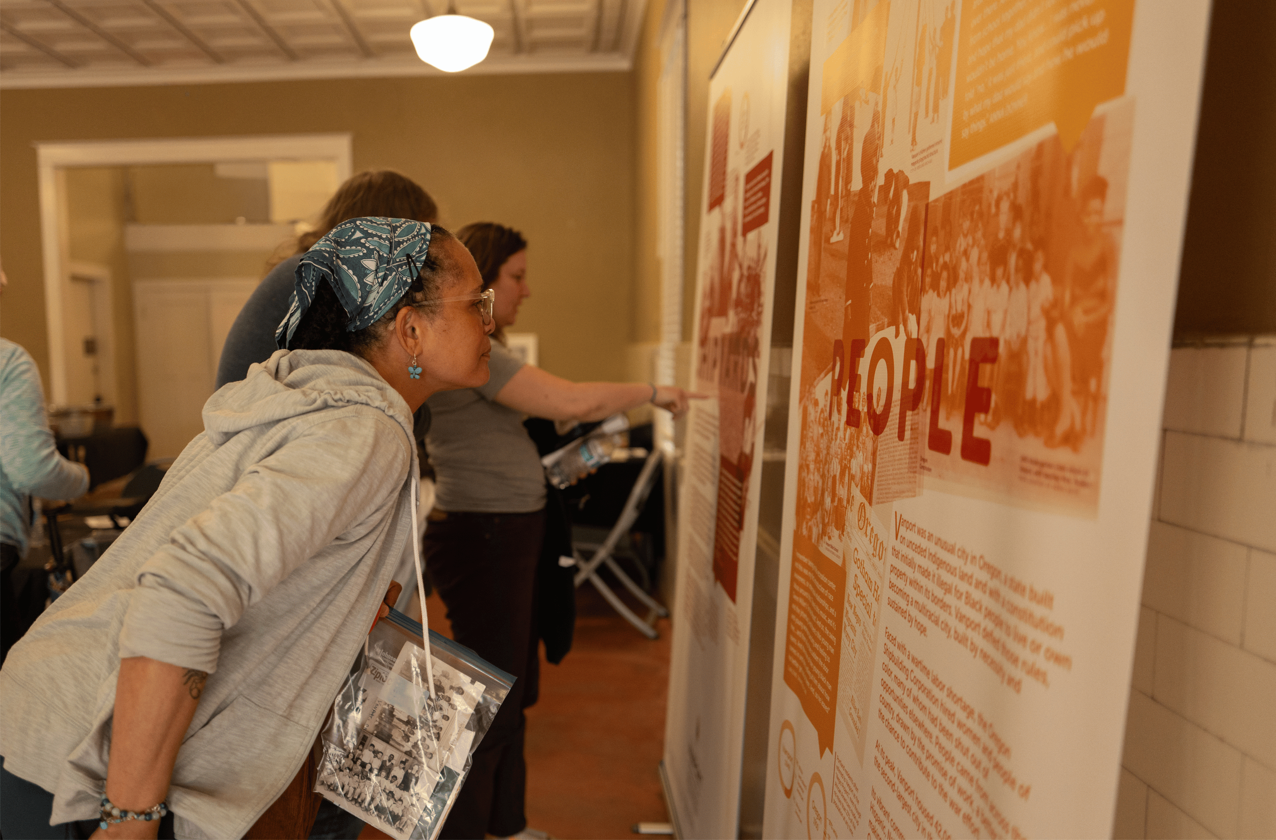  Event attendees visiting the Vanport Mosaic traveling exhibit,  Vanport: A Story Lived, A Story Told , on display at the Kenton Historic Firehouse during Kenton Roots on September 12, 2026.  Photo: Troy Winslow / Vanport Mosaic.  