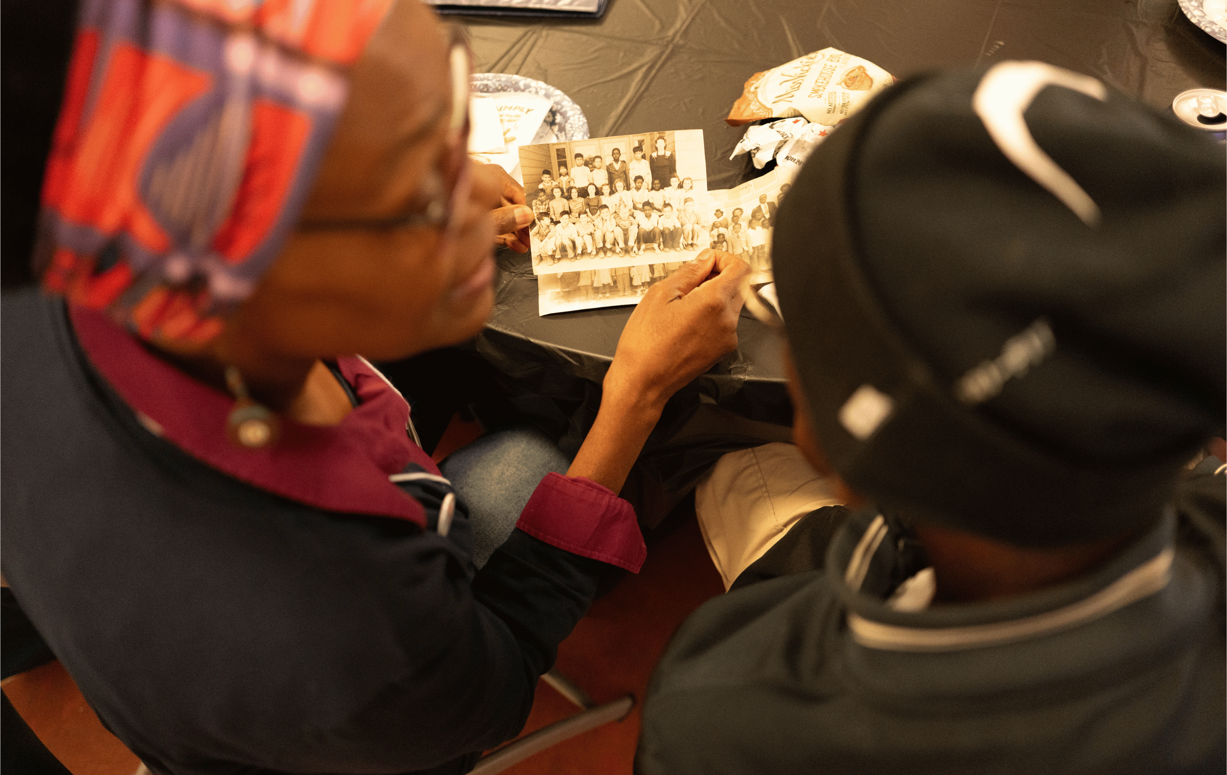  Vanport survivor Ed Washington and descendant LaVeta Gilmore Jones reviewing a historic photograph of Vanport schoolchildren during the Story Harvest at the Kenton Historic Firehouse for Kenton Roots on September 12, 2026.  Photo: Troy Winslow / Van