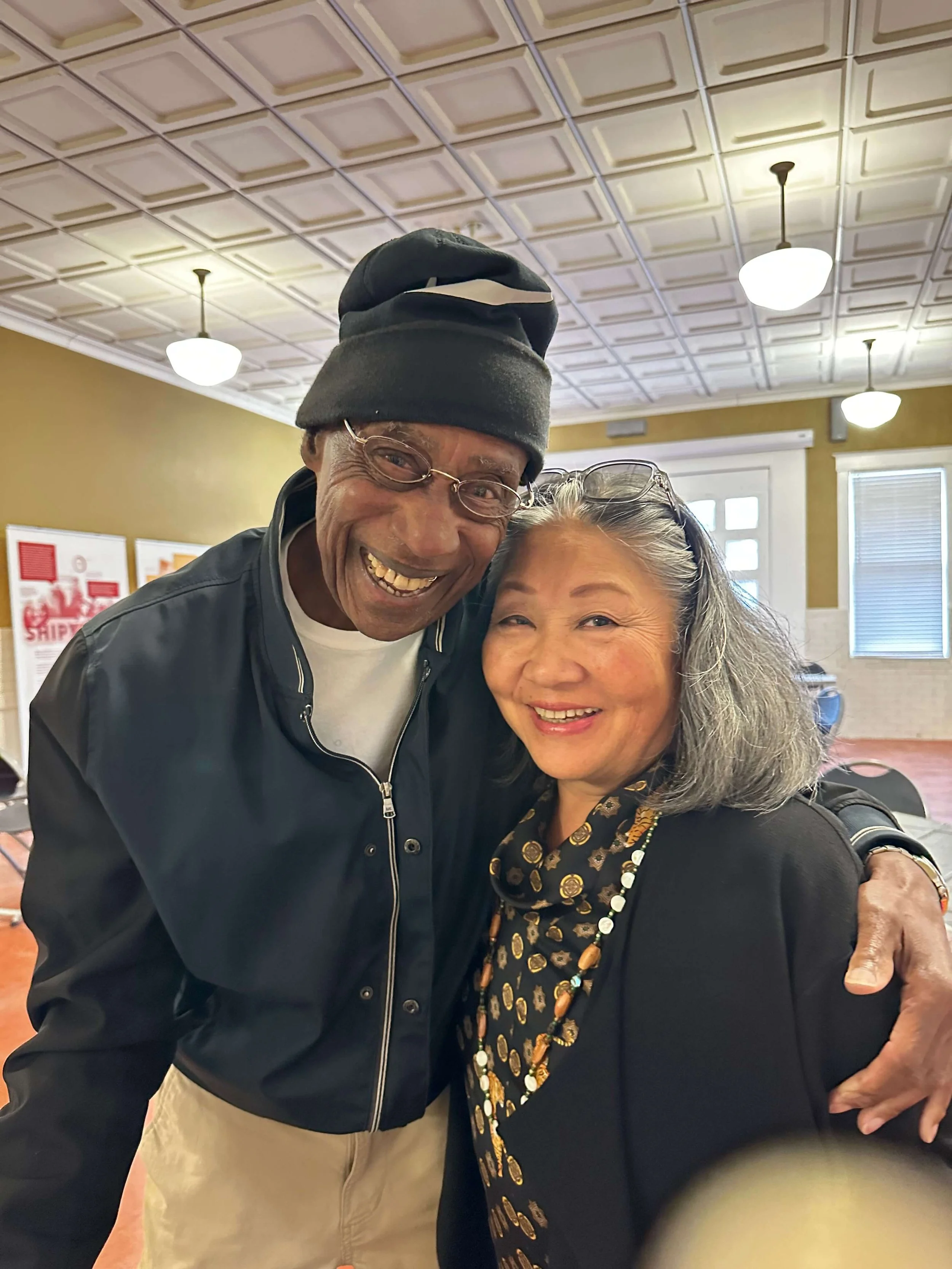  Kenton Roots docents Ed Washington (Vanport survivor) and Chisao Hata (artist and community organizer) at the Kenton Historic Firehouse during Kenton Roots on September 12, 2026.  Photo: Greta Smith / Vanport Mosaic  