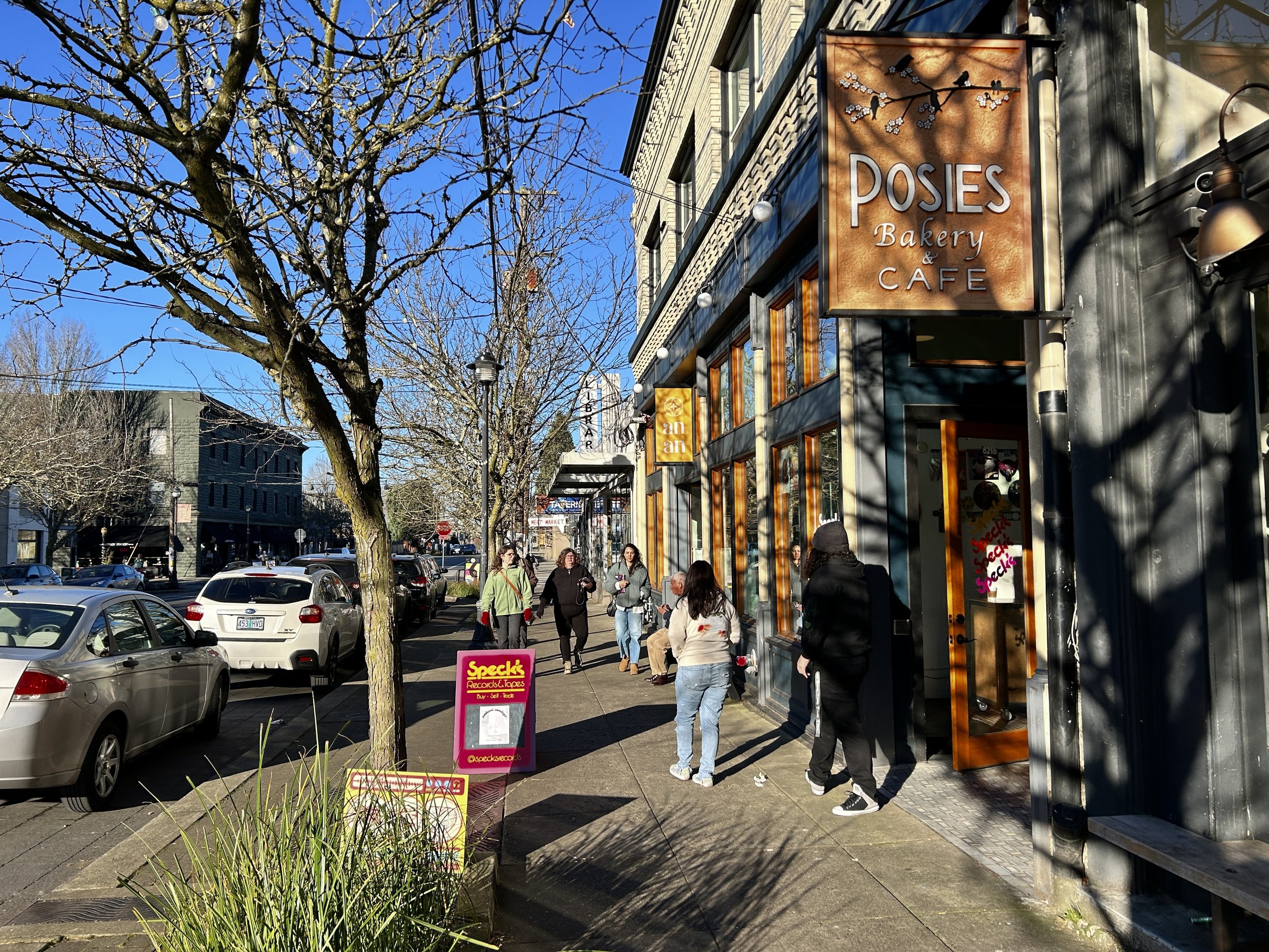 On a sunny day, people stroll along downtown Kenton's N Denver, visiting local shops and eateries. 