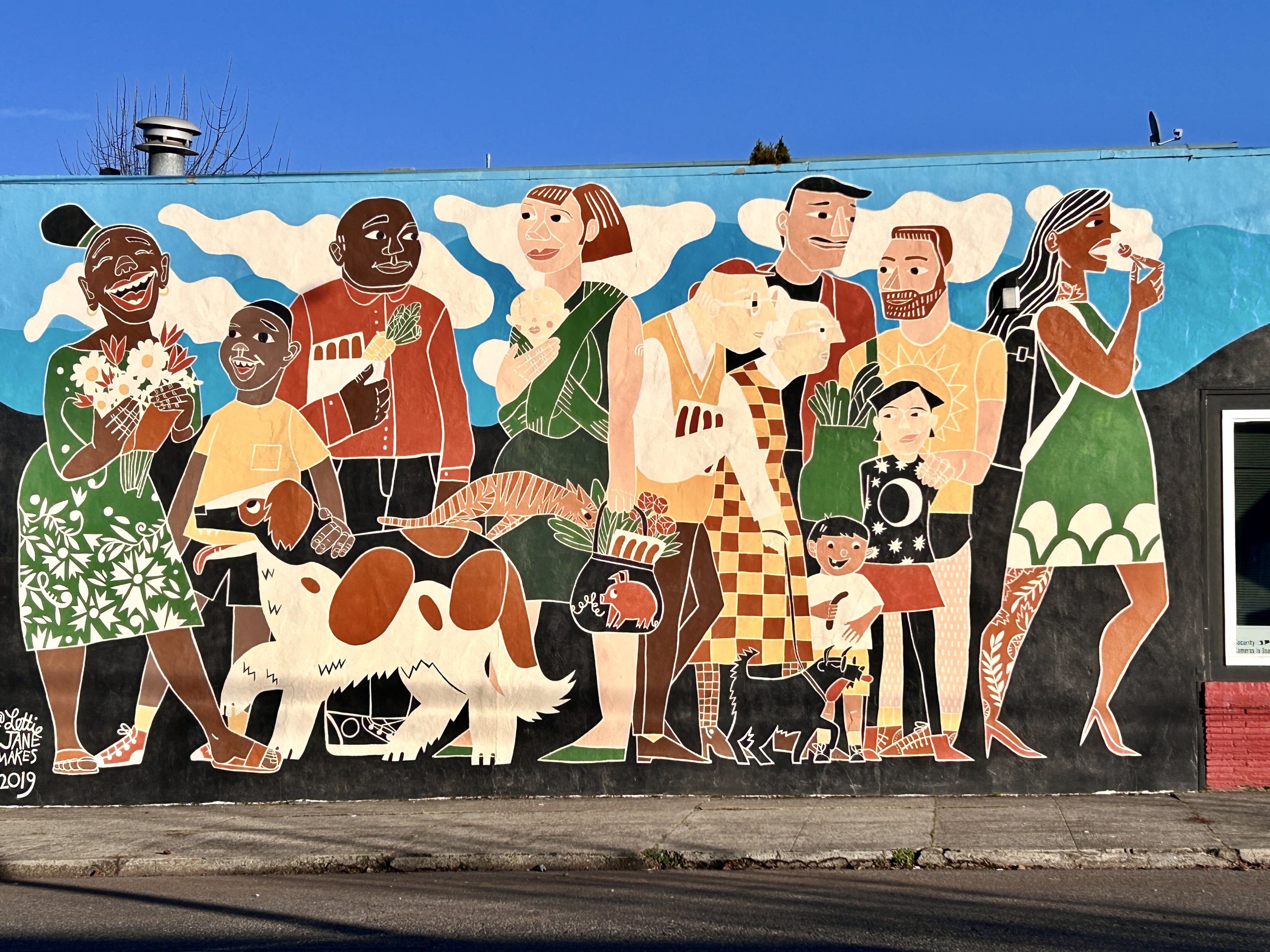 Scratch Meats mural by Lettie Jane Rennekamp; the vibrant mural depicts people of all ages and backgrounds laughing and engaging with each other.