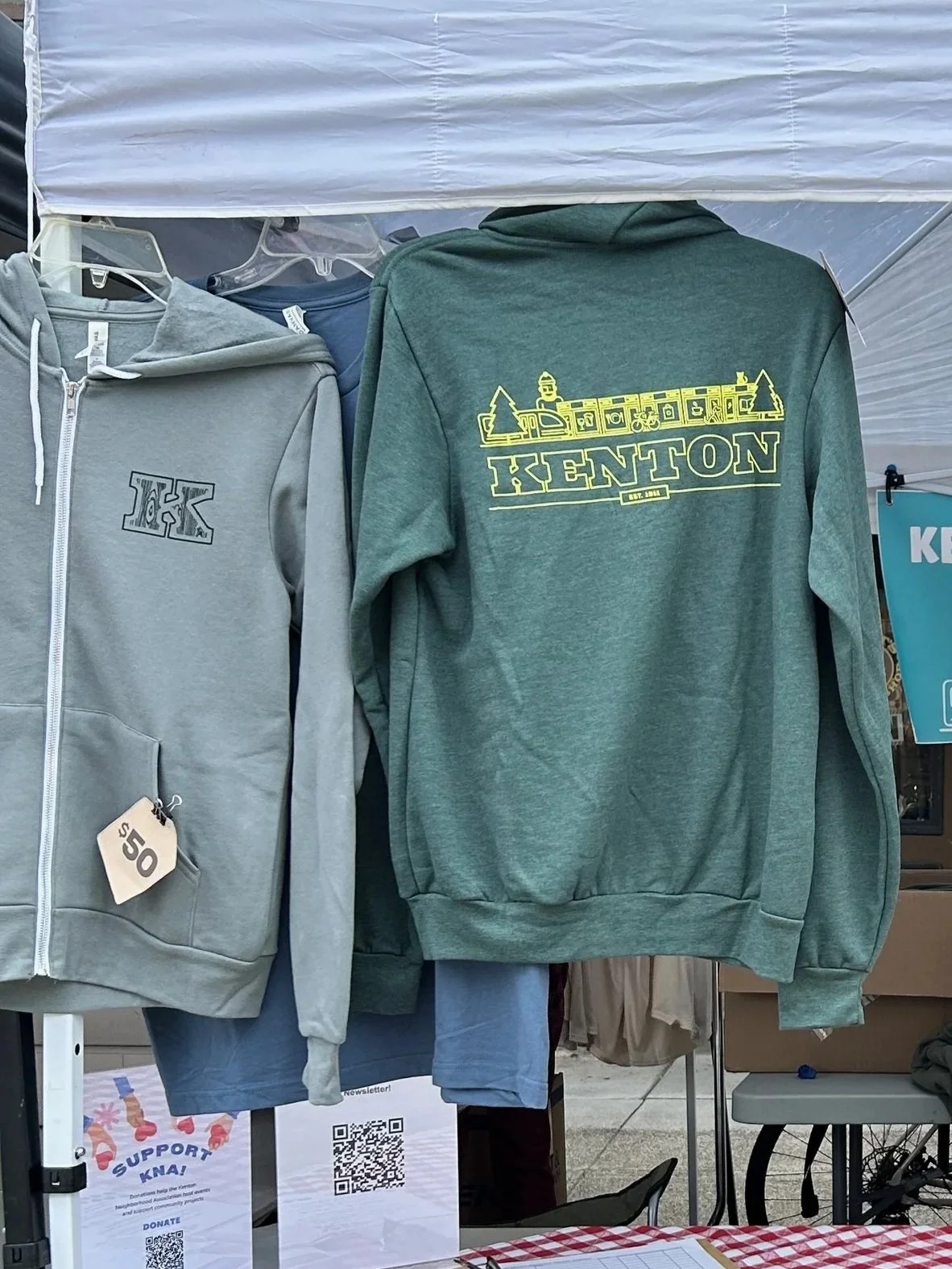 Two green sweatshirts with the Kenton logo.