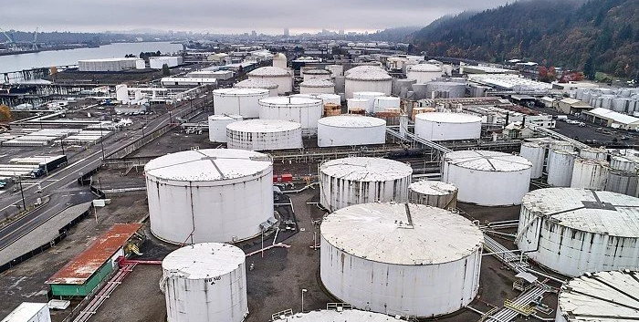 Aerial view of dozens of industrial chemical tanks.