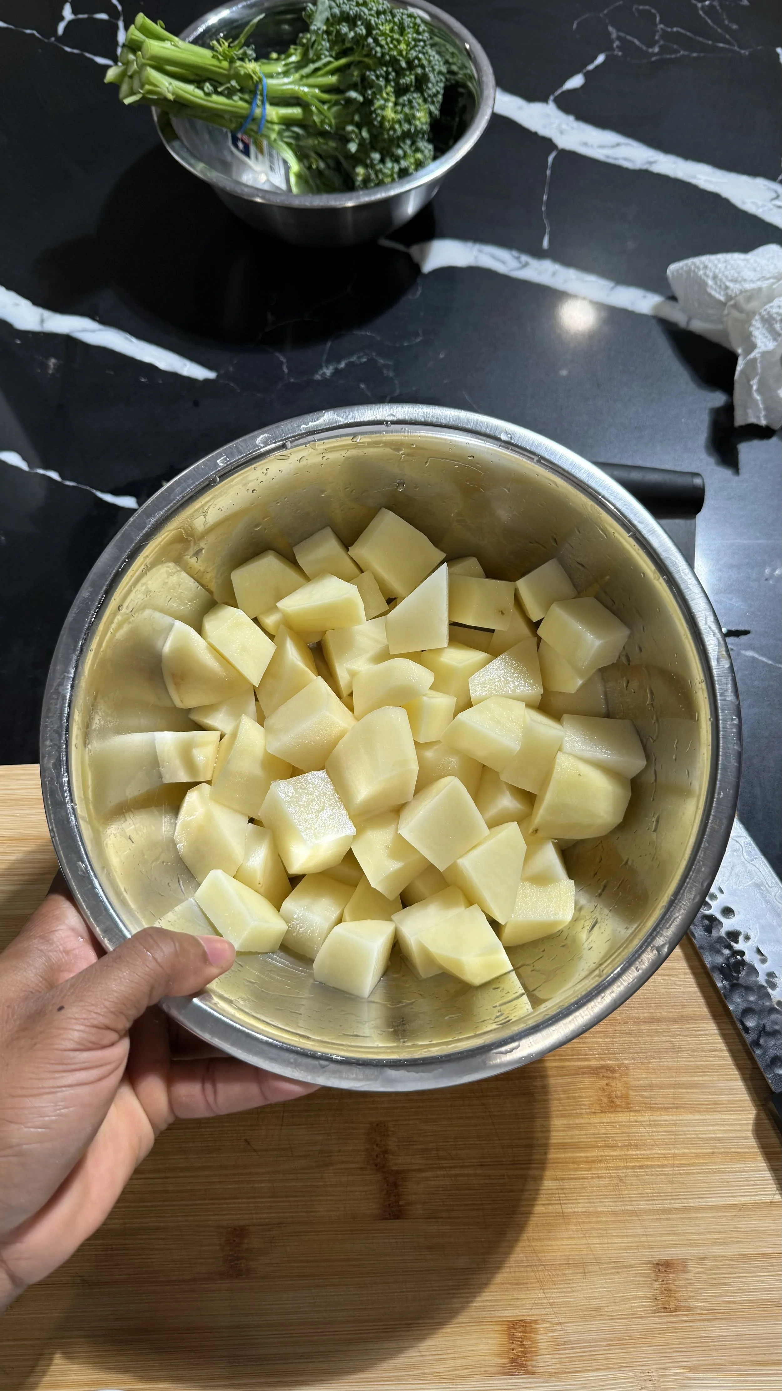 Peeled and cubed potatoes in a mixing bowl prepared for creamy mashed potatoes.