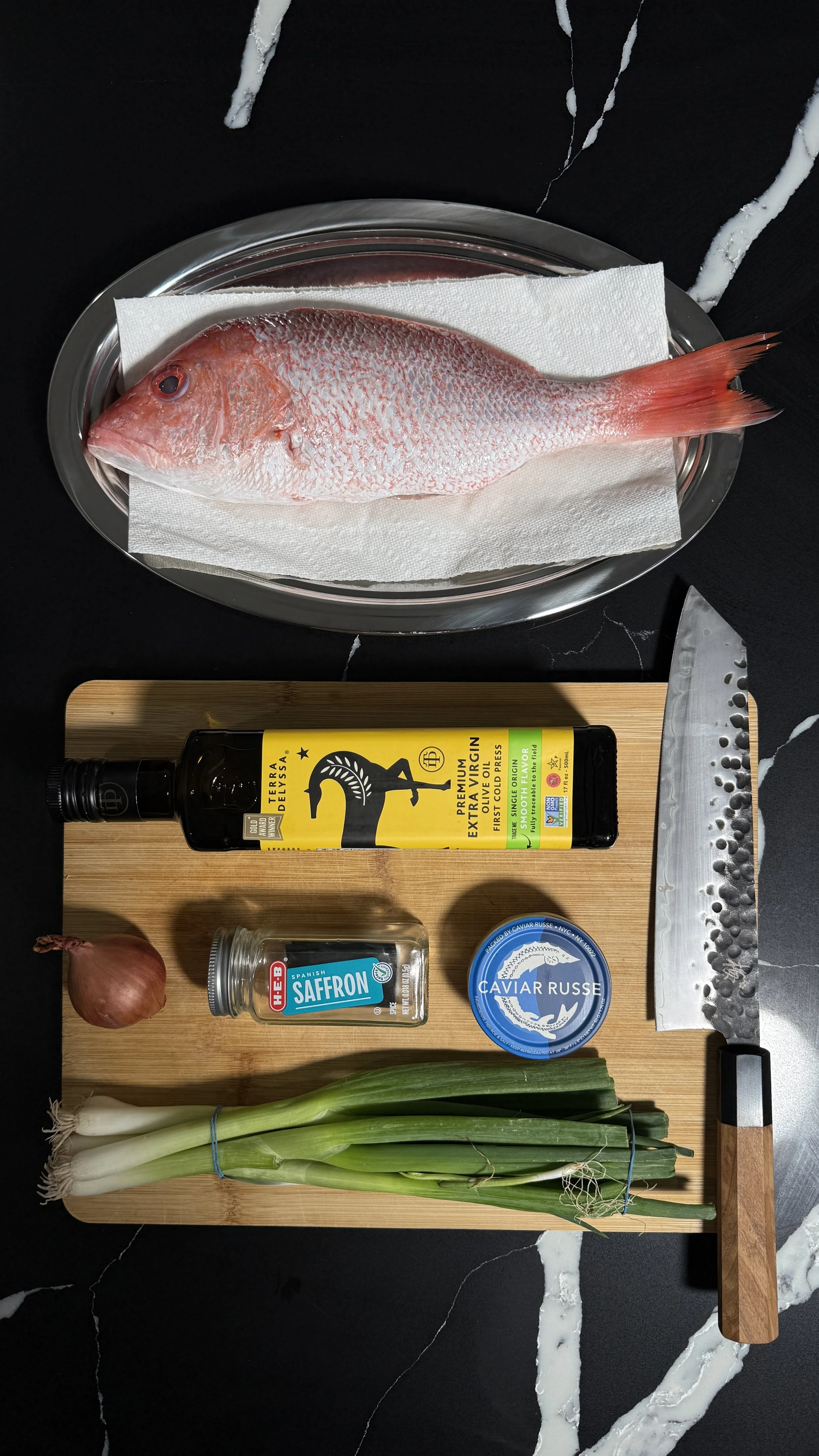 Whole raw red snapper on tray before seasoning