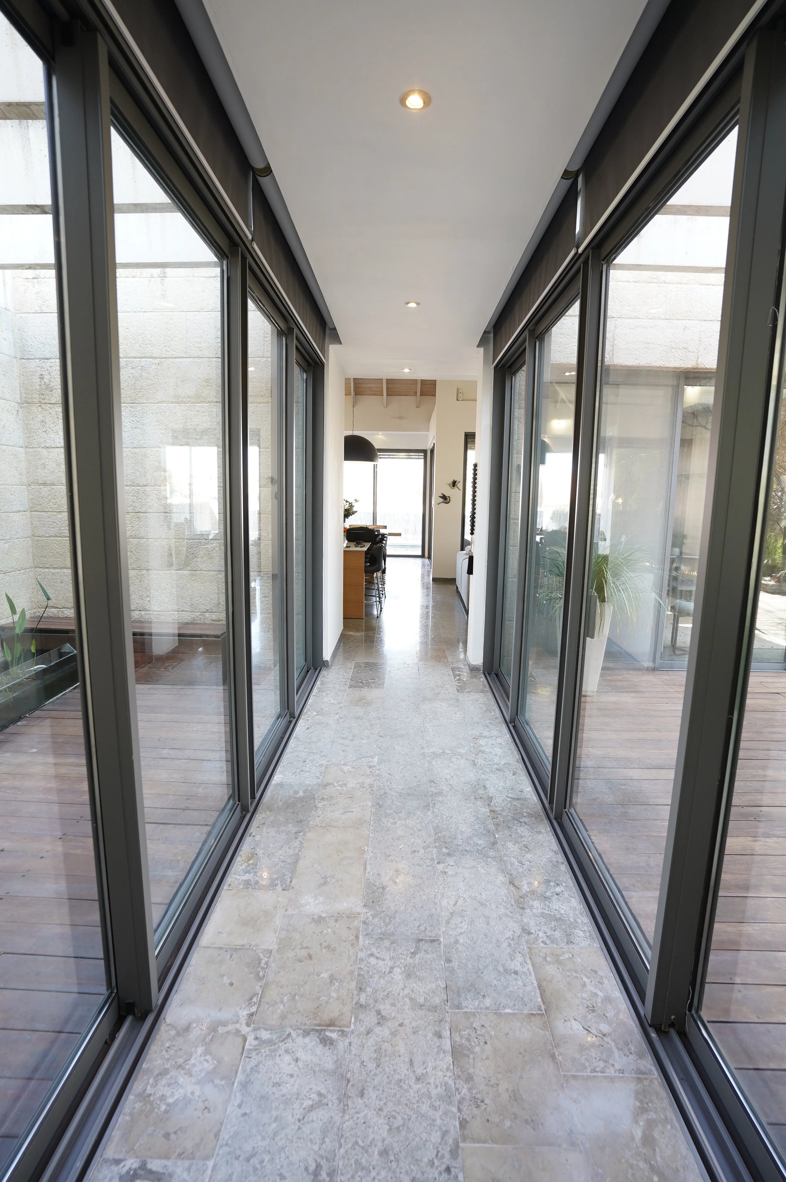 Glass corridor connecting interior space with courtyard