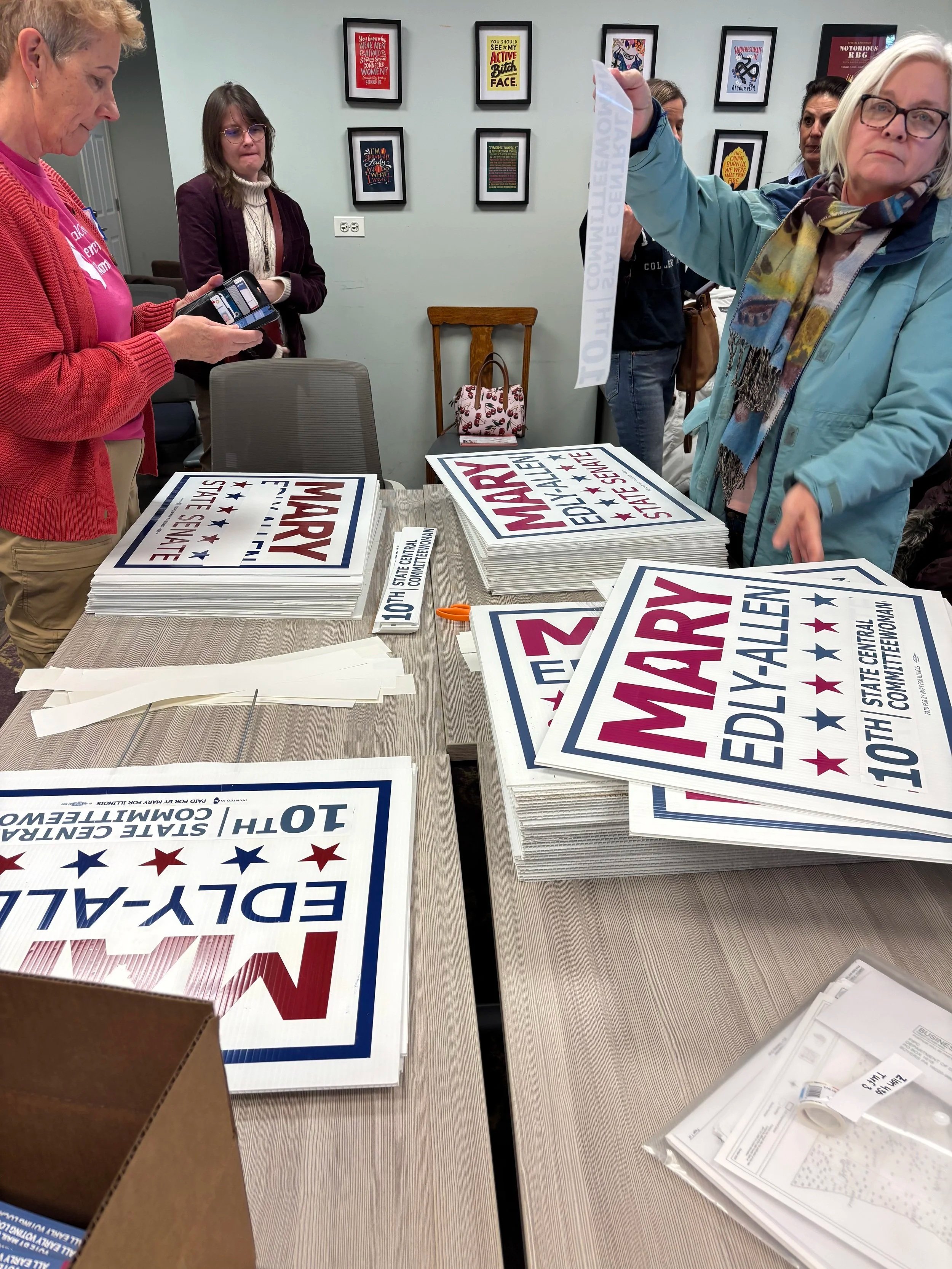 Volunteers upcycled Mary Edly-Allen for State Senate Yard Signs into Mary Edly-Allen for 10th District Central Committee Yard Signs by applying stickers.