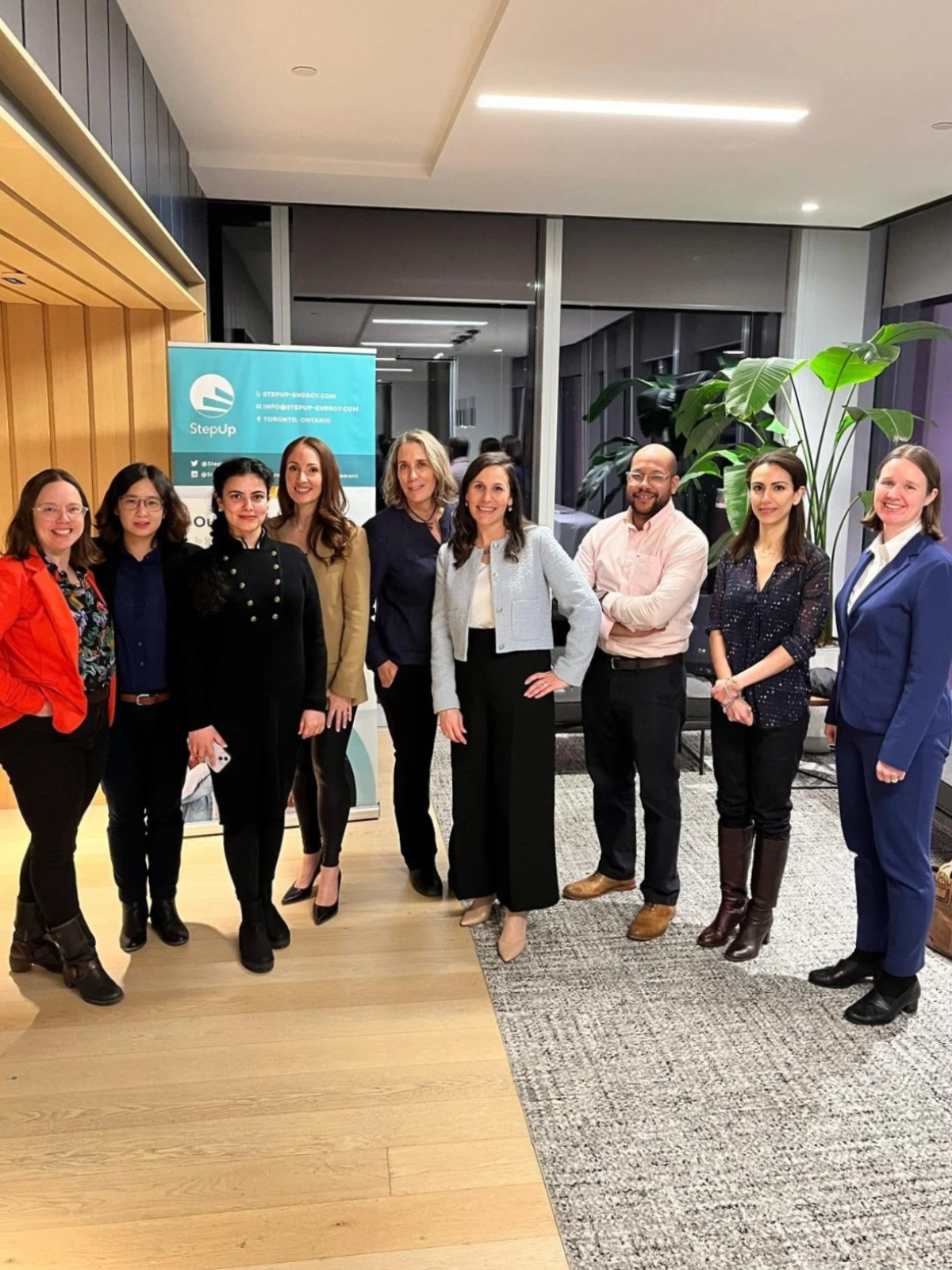 A building on a green hill with mountains in the background, some snow on the peaks.