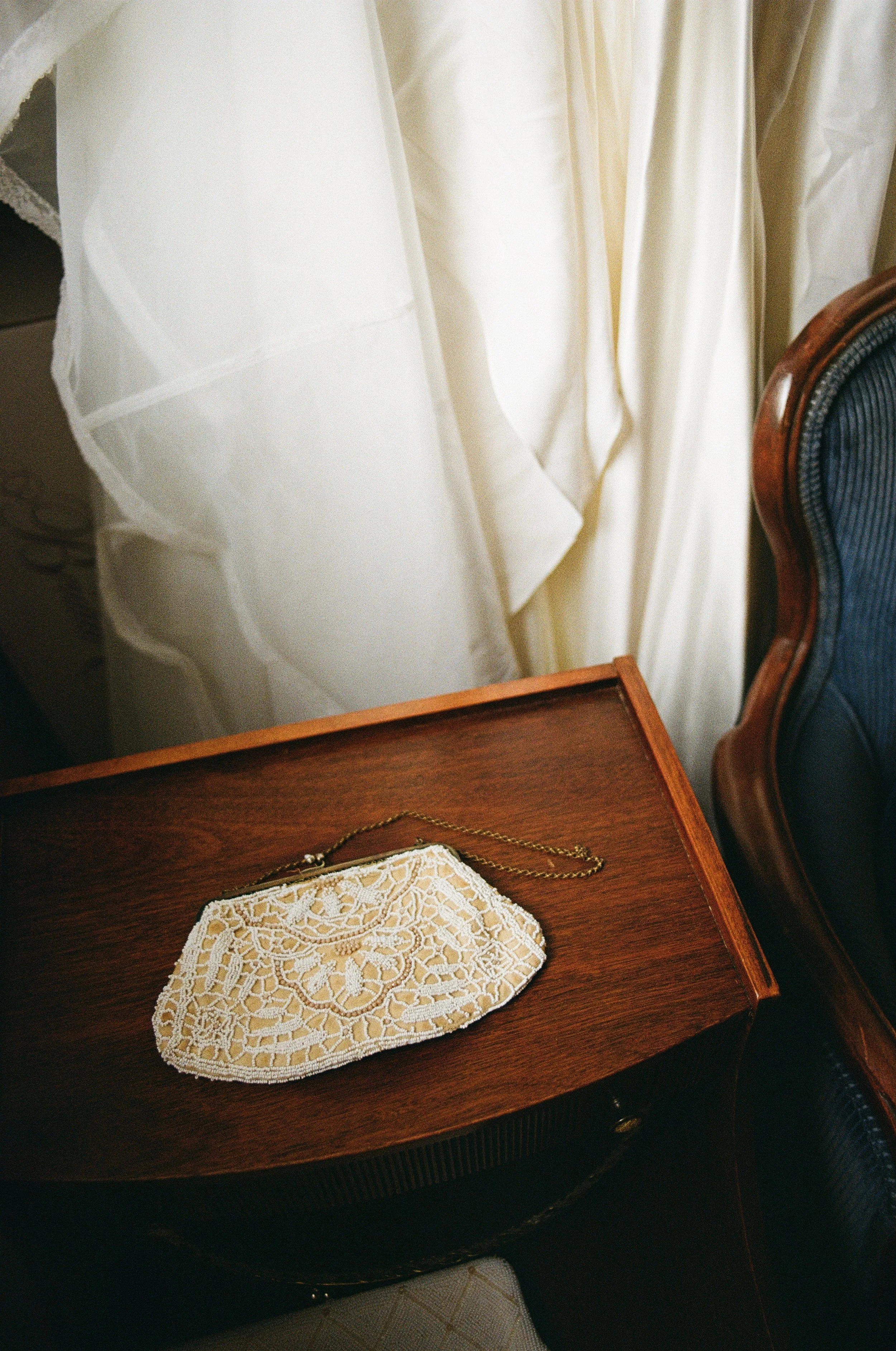 A cream and white, beaded vintage purse or handbag