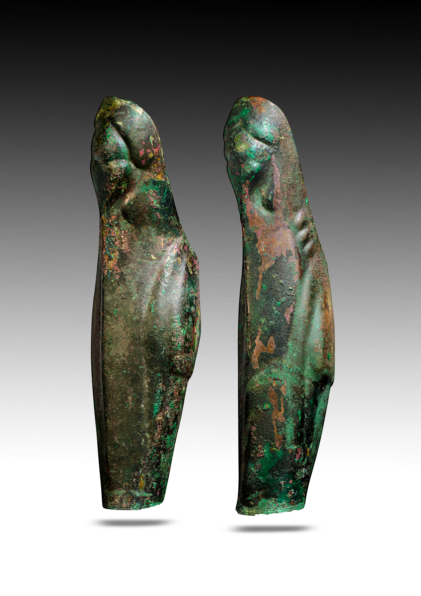 Two ancient bronze objects resembling stylized human limbs, with a green patina and hints of reddish corrosion, floating against a gradient gray background.