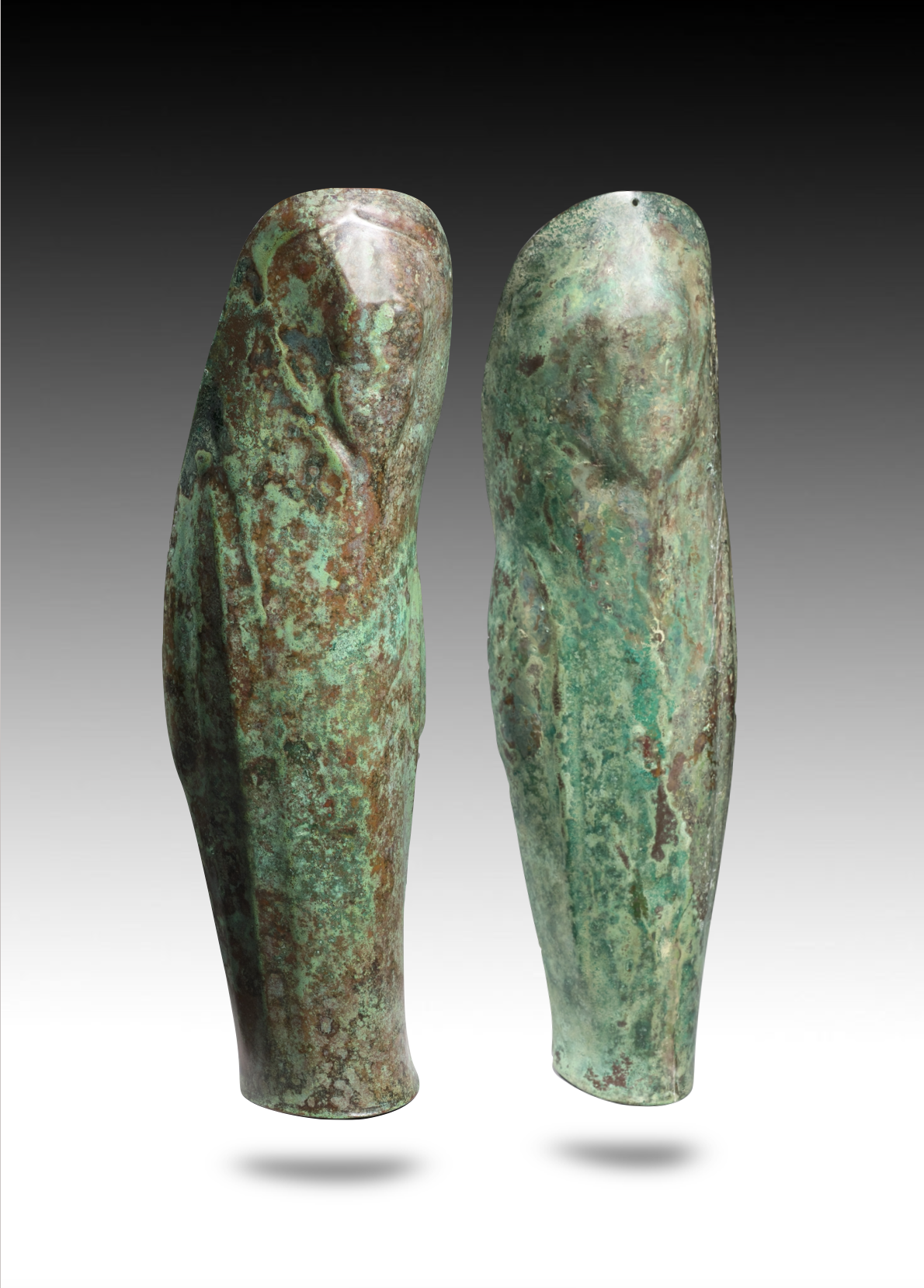 Ancient bronze artifacts shaped like human finger phalanges with a green patina.