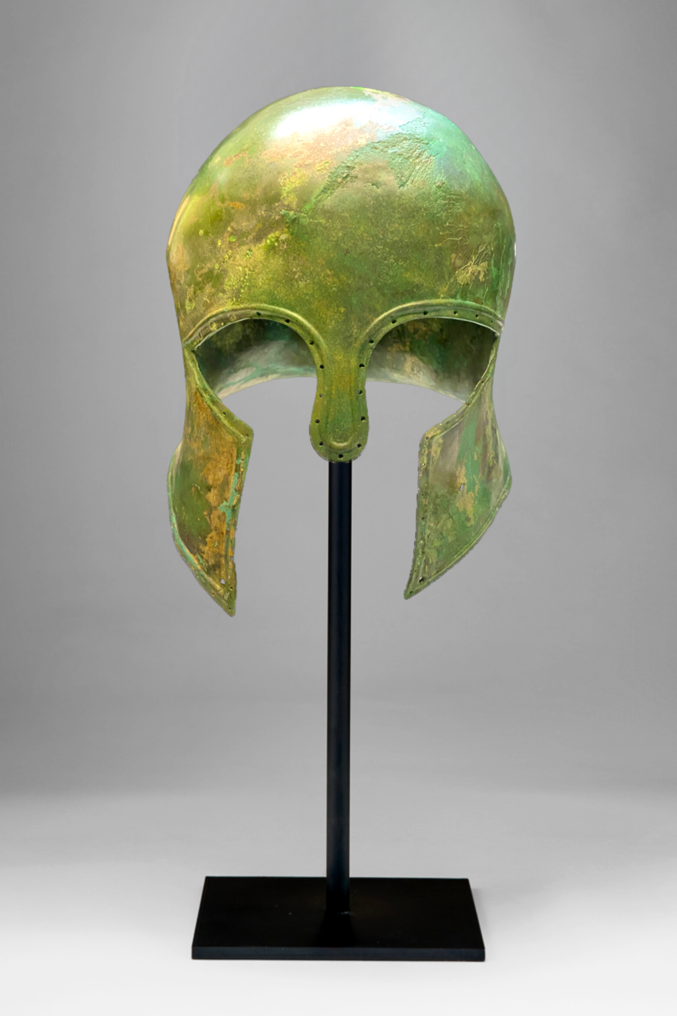 Metallic green helmet with a vintage design, displayed on a black stand against a gray background.