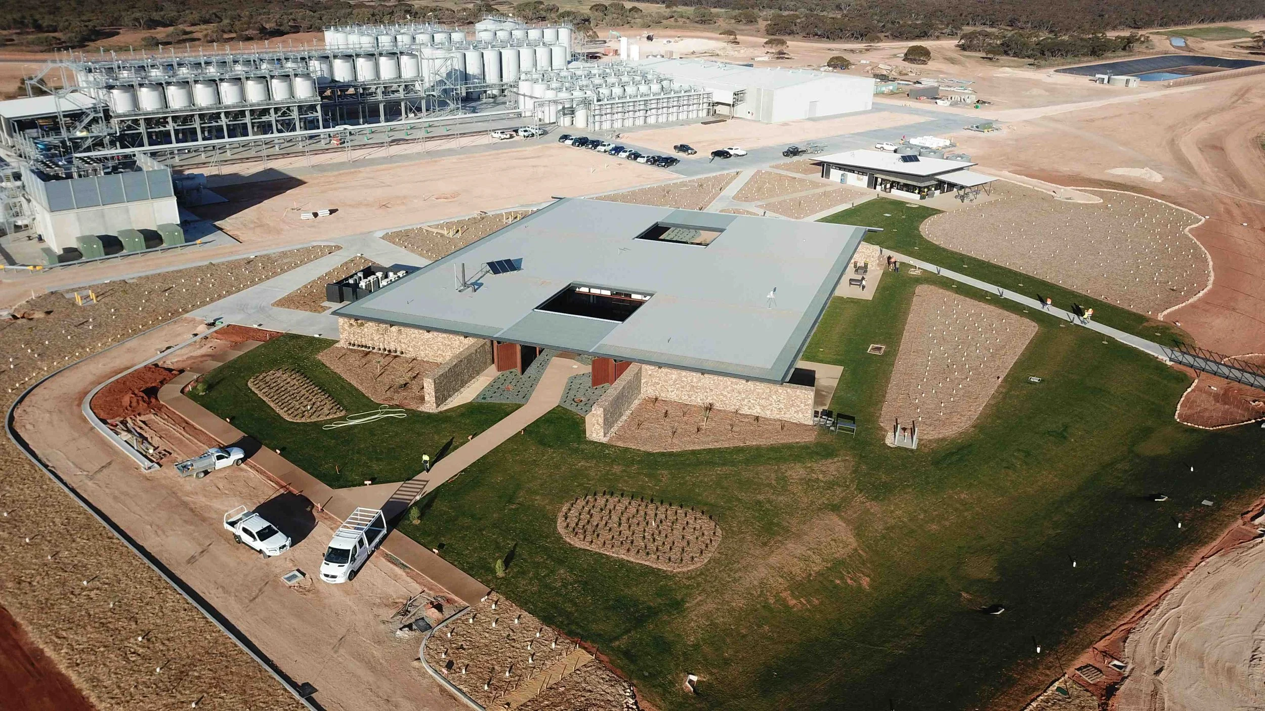 Aerial view of a contemporary commercial facility integrated into a master-planned industrial precinct with landscaped grounds and supporting infrastructure.