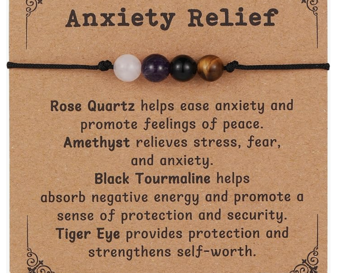 A bracelet with four beads in purple, black, and brown, displayed above text about anxiety relief herbs on a brown background.