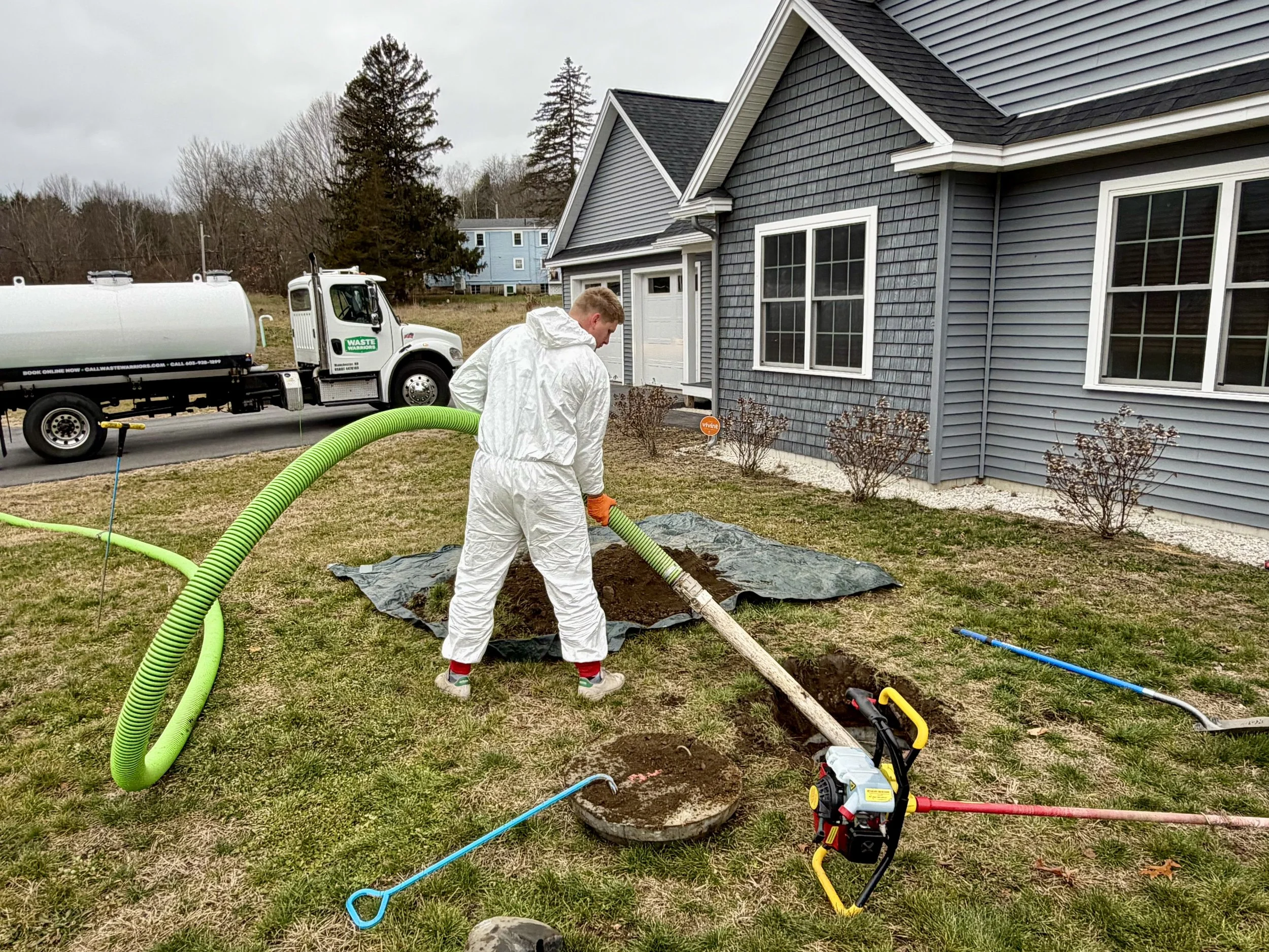 A technician from Emergency Septic on a job pumping a septic tank for a customer that had a septic emergency.