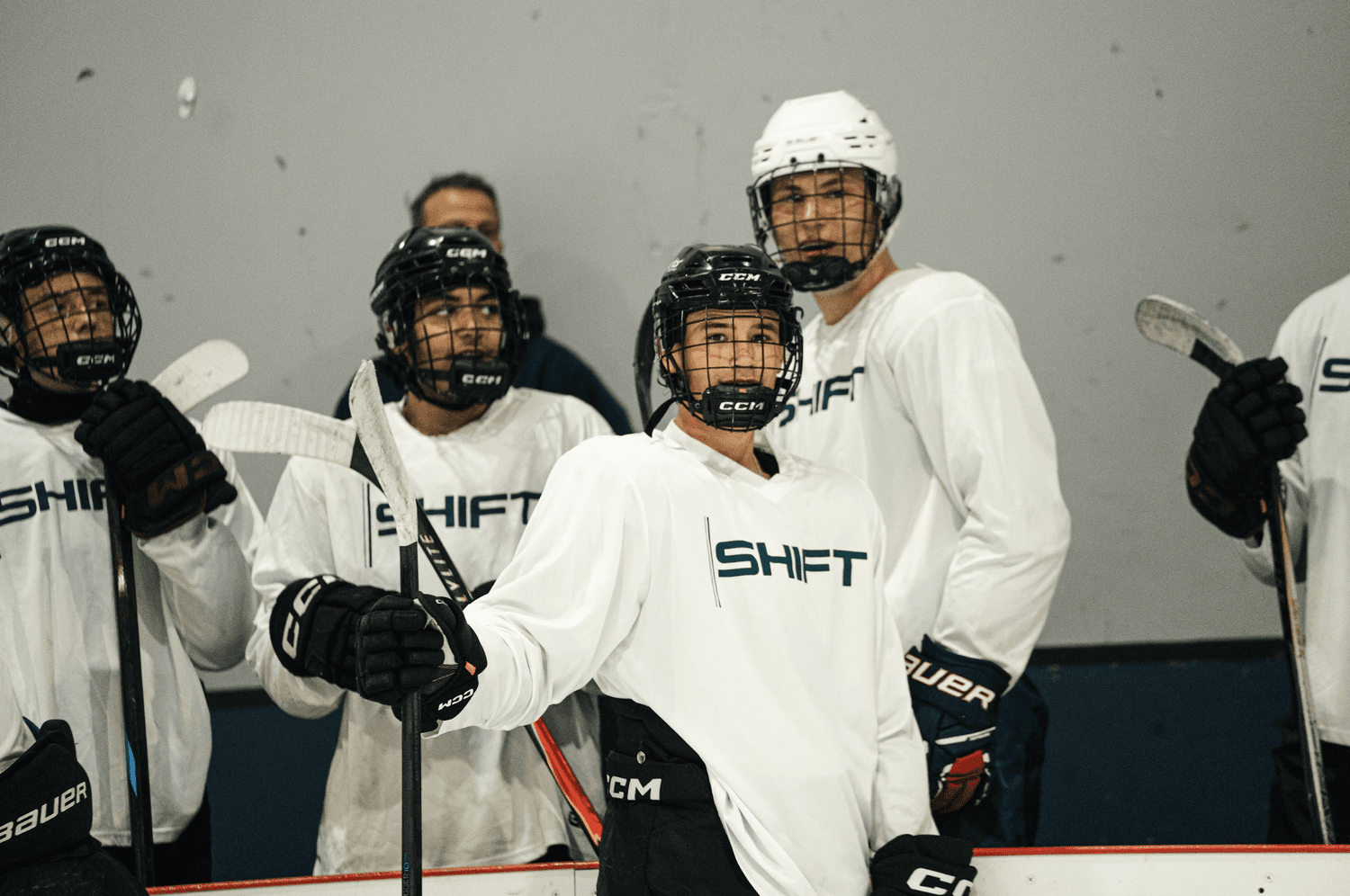 Shift27 athletes on the ice in white team jerseys