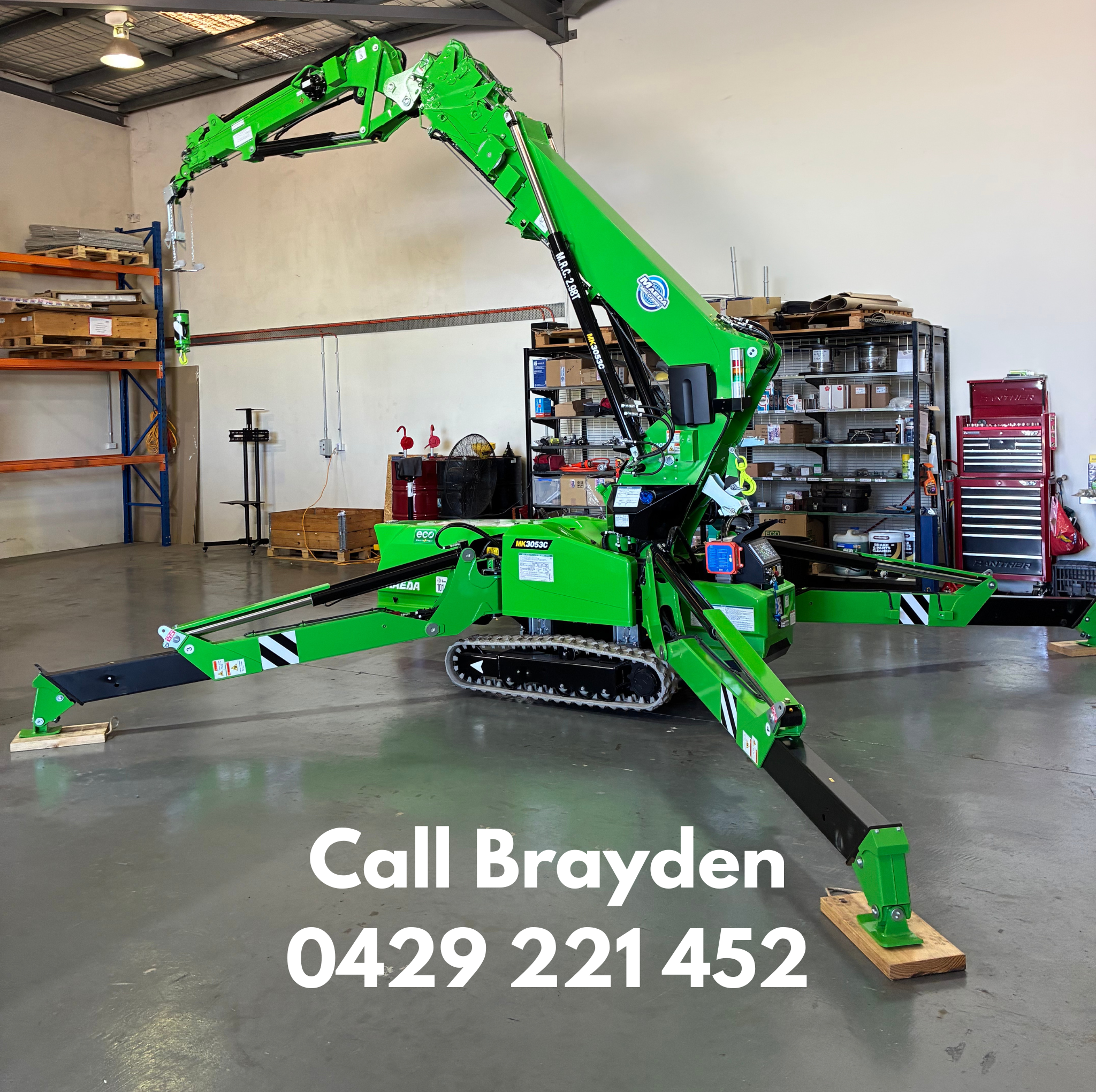 Green portable crane with extendable boom in a warehouse. Contact Brayden 0429221452