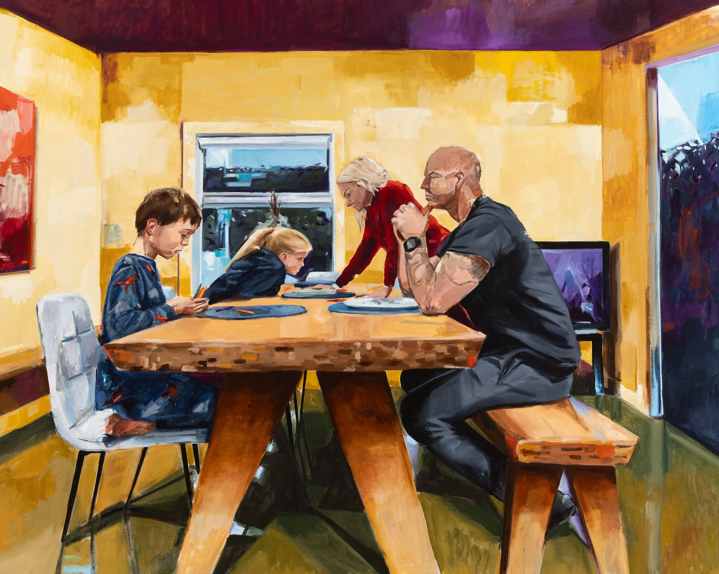 A family gathered around a wooden dining table in a brightly colored room with yellow walls. Two children are on one side looking at devices, while two adults, a woman with blonde hair and a man with tattoos and glasses, are on the other side. The woman is leaning over the table, and the man is sitting on a bench, both engaged in the scene.