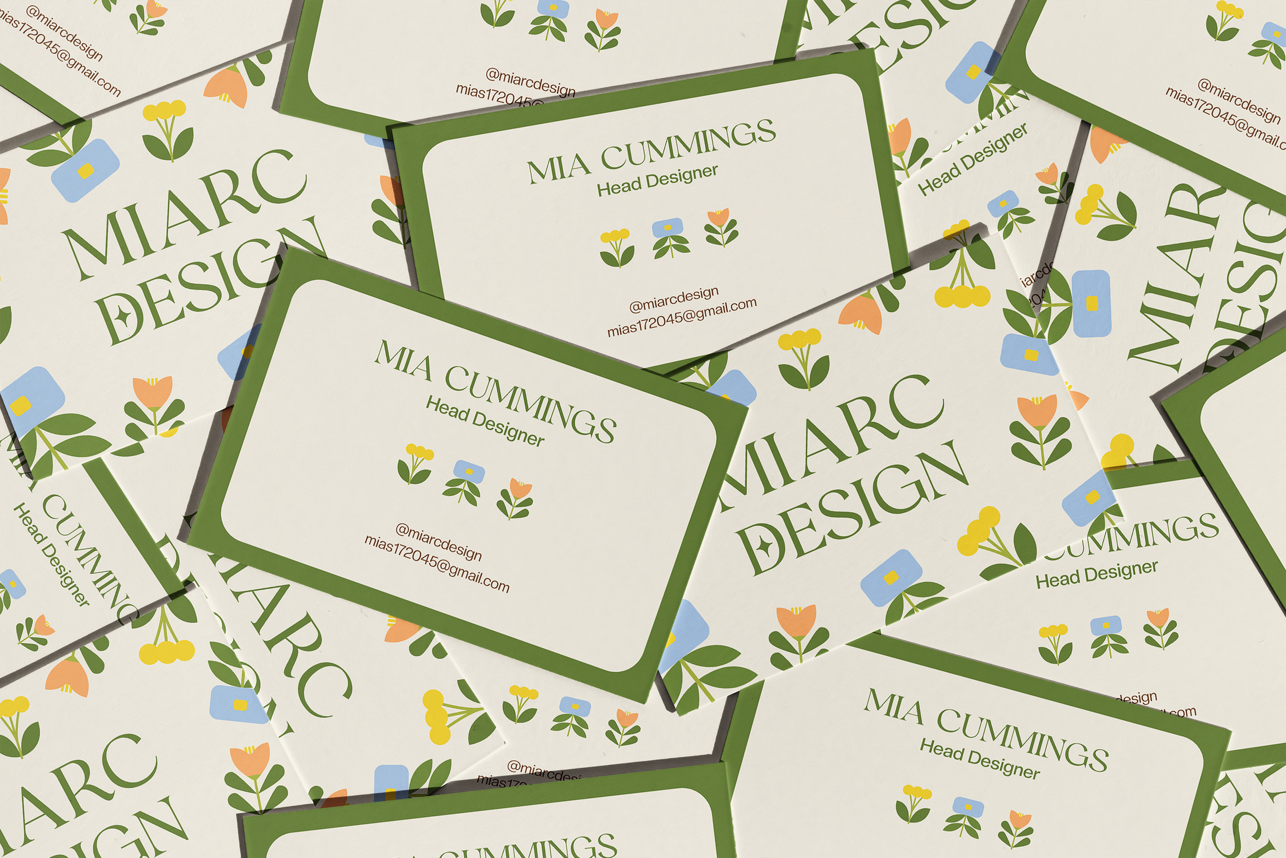 Business cards for Mia Cummings, Head Designer, with a floral pattern and green border, displaying her contact information and social media handle.