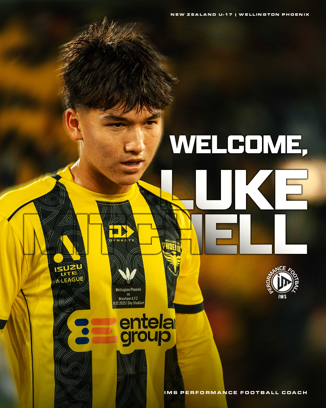 A young male soccer player in a yellow and black jersey, looking down with a serious expression, standing on a soccer field with a blurred background. Text overlay reads "Welcome, Luke Mitchell" and details about a match between Wellington Phoenix and Wrexham A.F.C. on July 19, 2025.