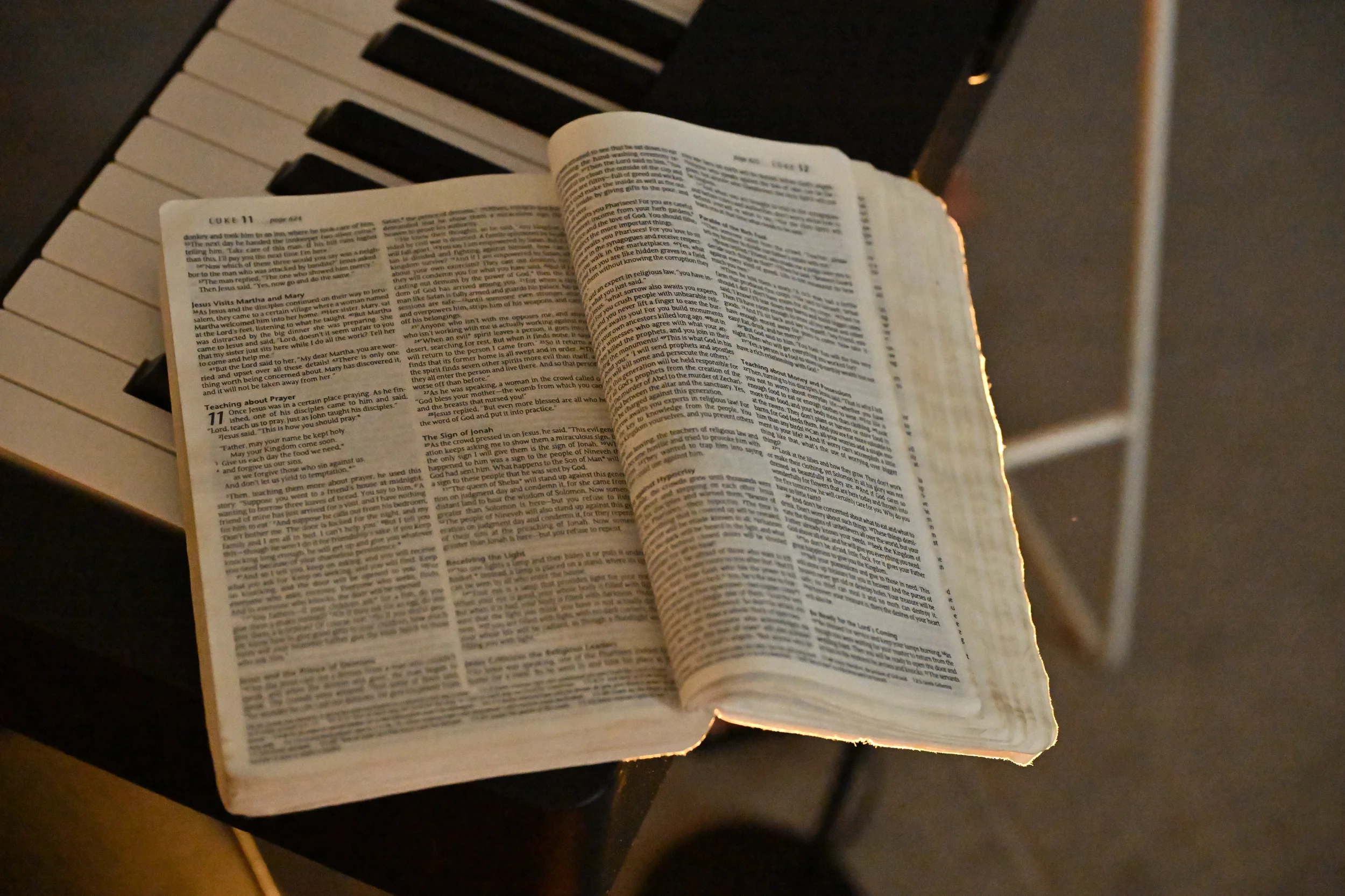 A bible open to Luke 10 resting on a keyboard