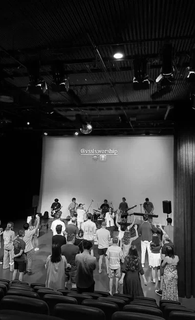 People gathered to worship in a school hall