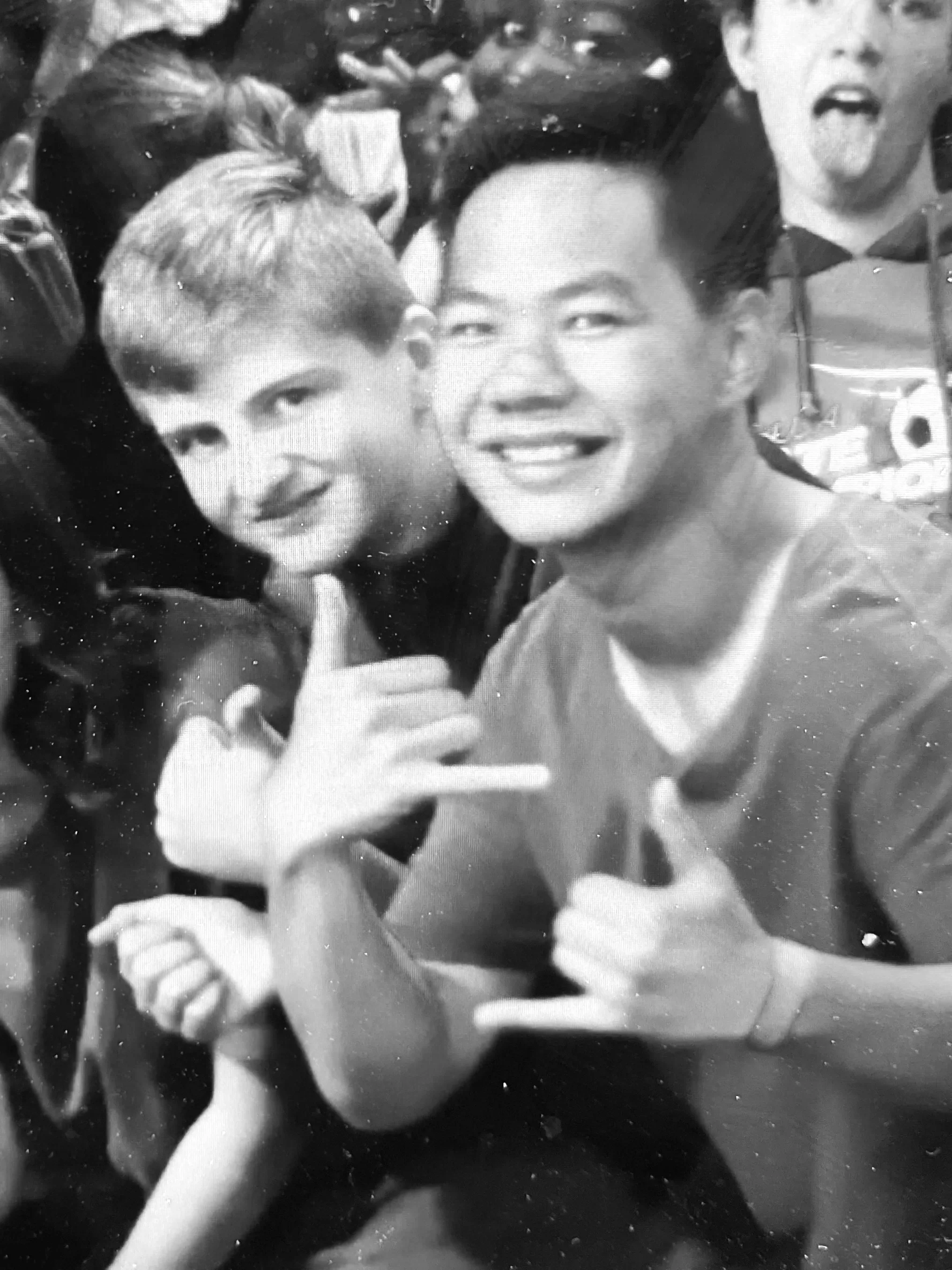 Joel Chan and Luke Howis at a youth camp, with more people in the background.