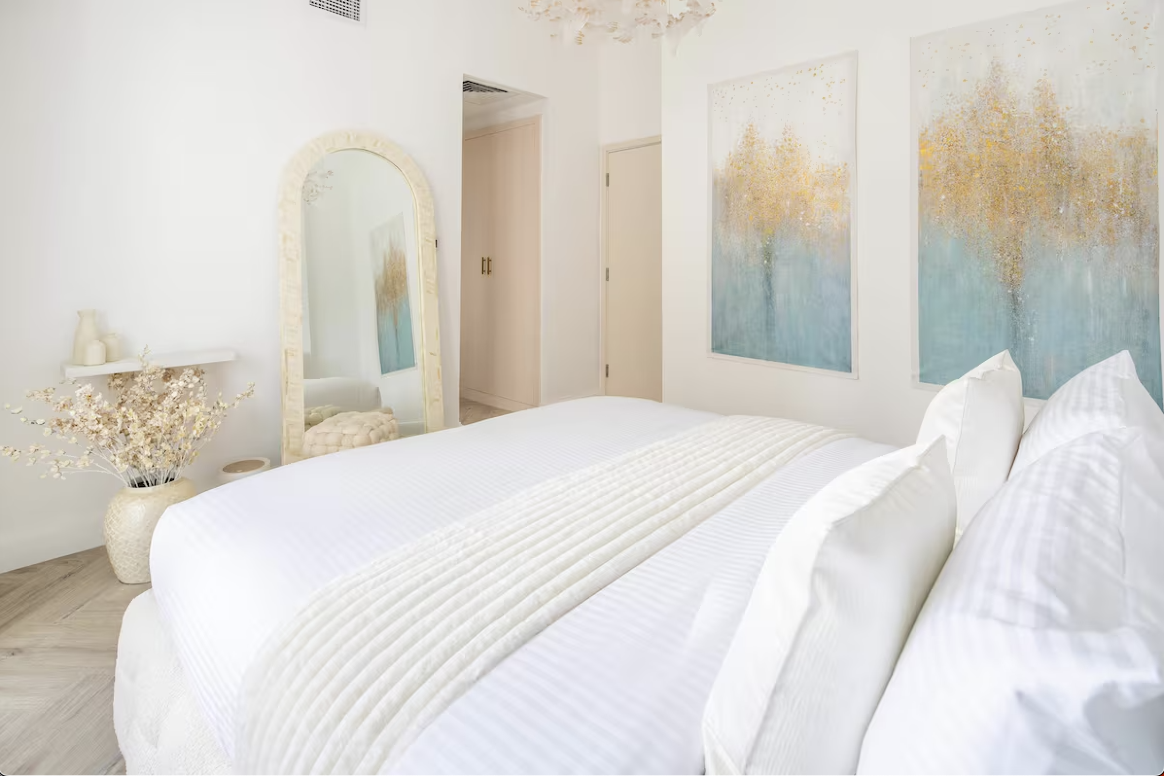 Bright, neutral bedroom with soft textures and curated details, creating a calm and elegant living space.
